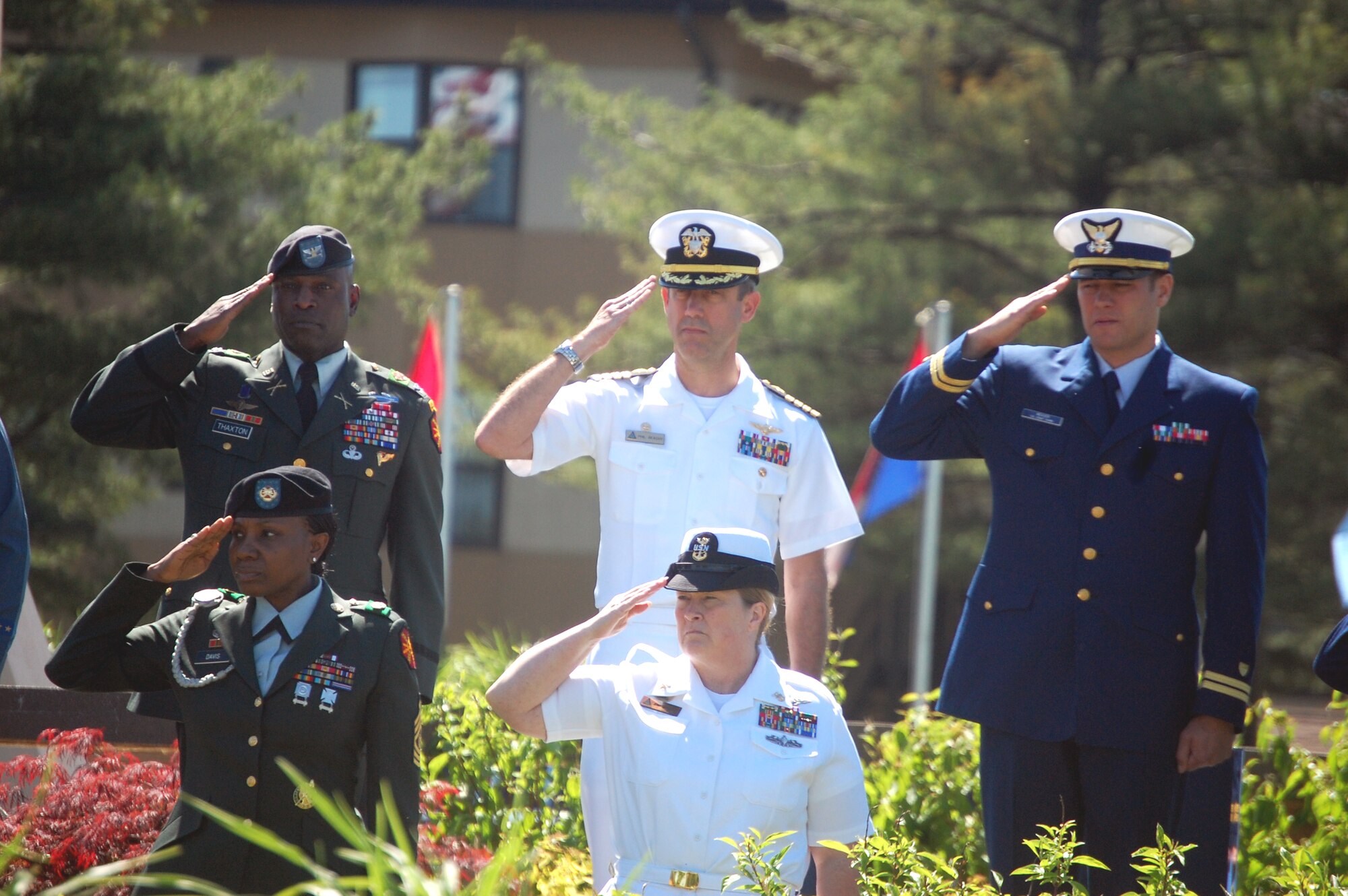 Members of the Army, Navy and Coast Guard salute during the playing of the national anthem at the 2009 Parade of Wreaths ceremony at Pudgy Circle on Joint Base McGuire-Dix-Lakehurst, N.J., on May 21.  The ceremony included members from all branches of the armed forces and from state and local police agencies.  The ceremony is held in observance of National Police Week and Memorial Day.  (U.S. Air Force Photo/Tech. Sgt. Scott T. Sturkol)