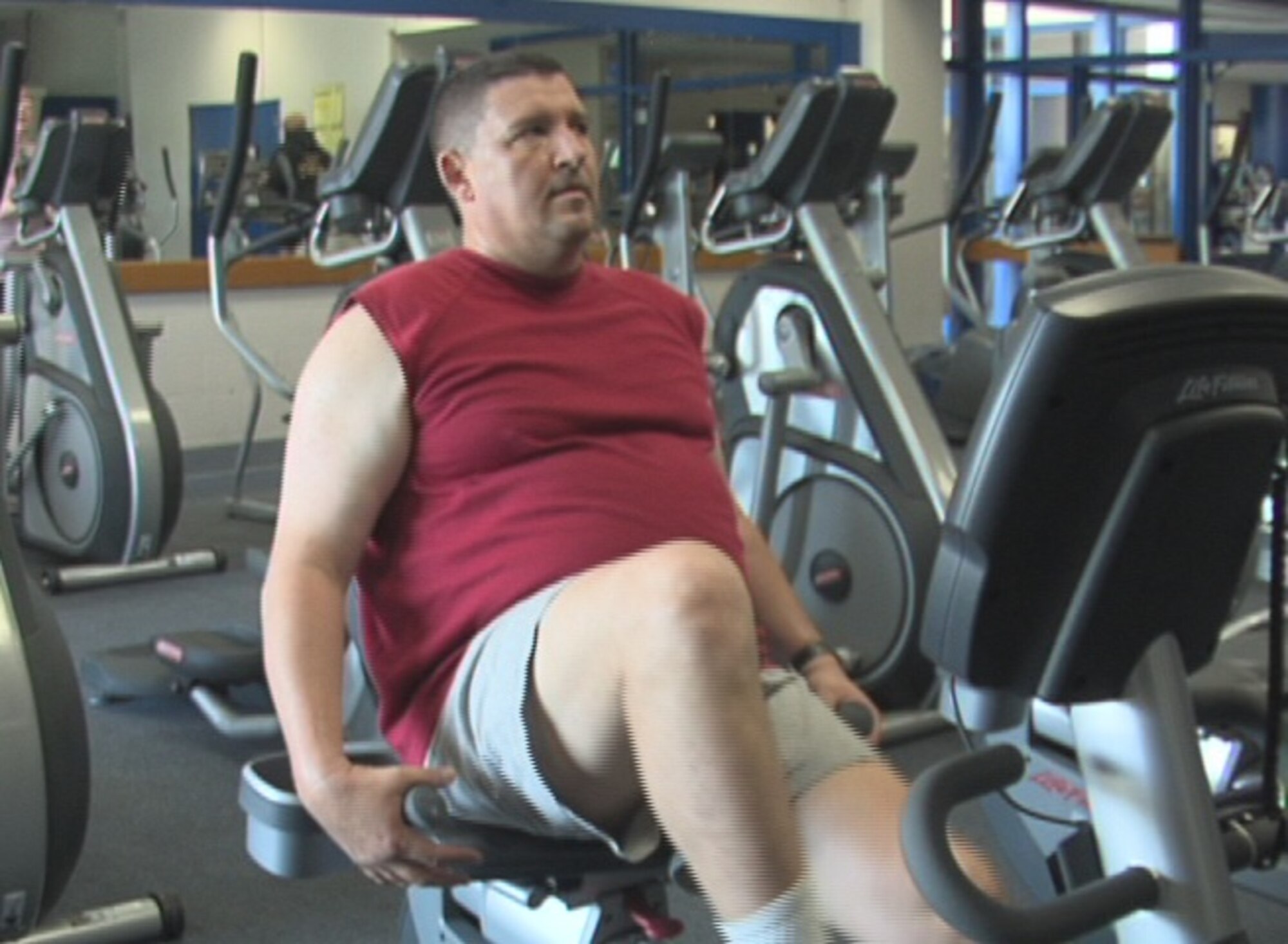 ALTUS AIR FORCE BASE, Okla. -- Tech. Sgt. T.J. Sinclair, 54th Air Refueling Squadron, rides the stationary bike in the base fitness center May 22. With the help of the Health and Wellness Center staff, Sergeant Sinclair has lost weight and improved his cardiovascular fitness in preparation for his annual fitness test. (U.S. Air Force photo/Kenneth A. Scarle)