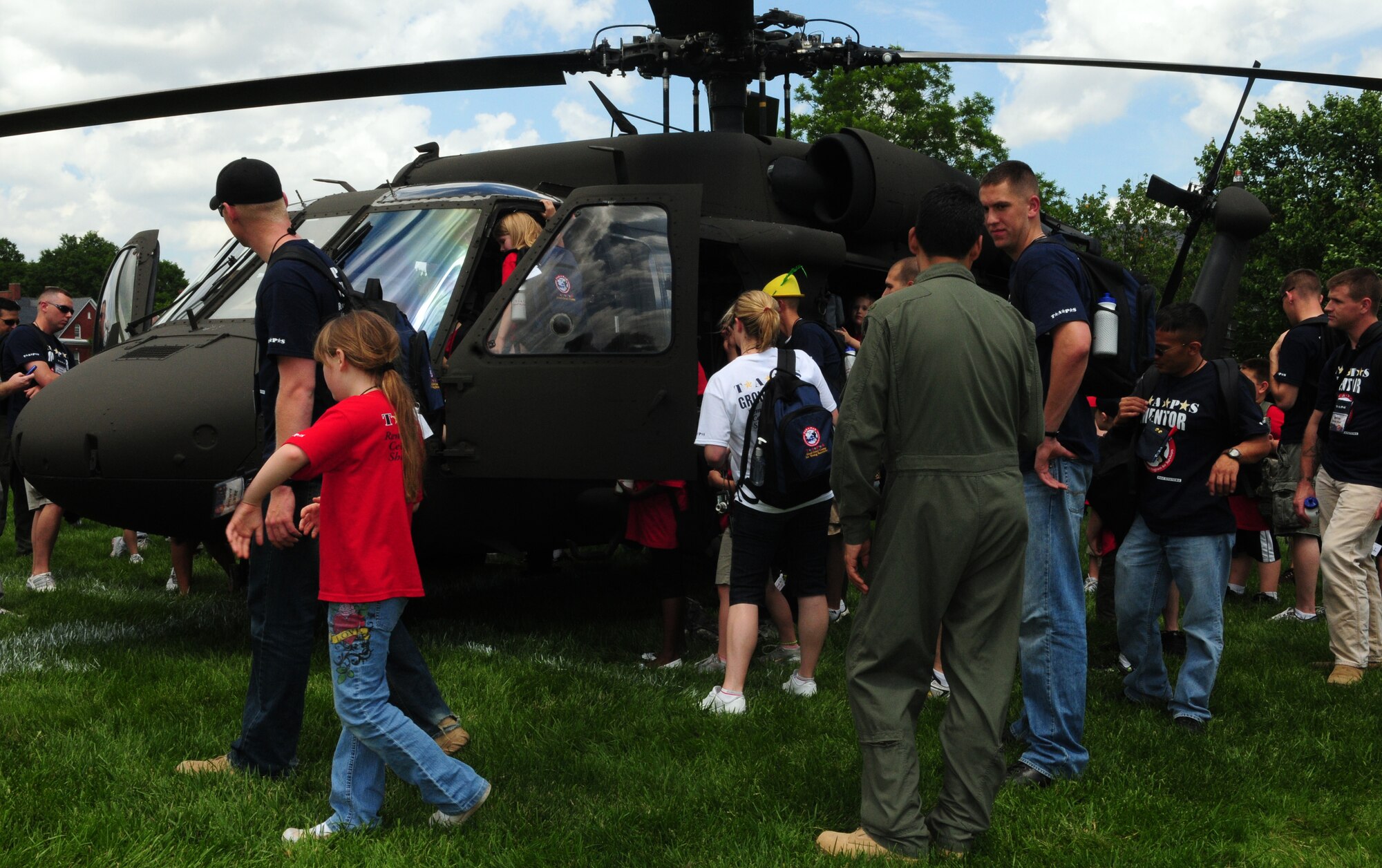 TAPS mentors and mentees explore the inside of a Blackhawk helicopter static display May 24 at Fort Myer, Va. TAPS is a non-profit organization created by Bonnie Carroll to provide peer-based emotional support, grief and trauma resources, case-work assistance and round-the-clock crisis intervention care for anyone affected by the death of a loved one serving in the military. (U.S. Air Force photo by Airman 1st Class Susan Moreno)