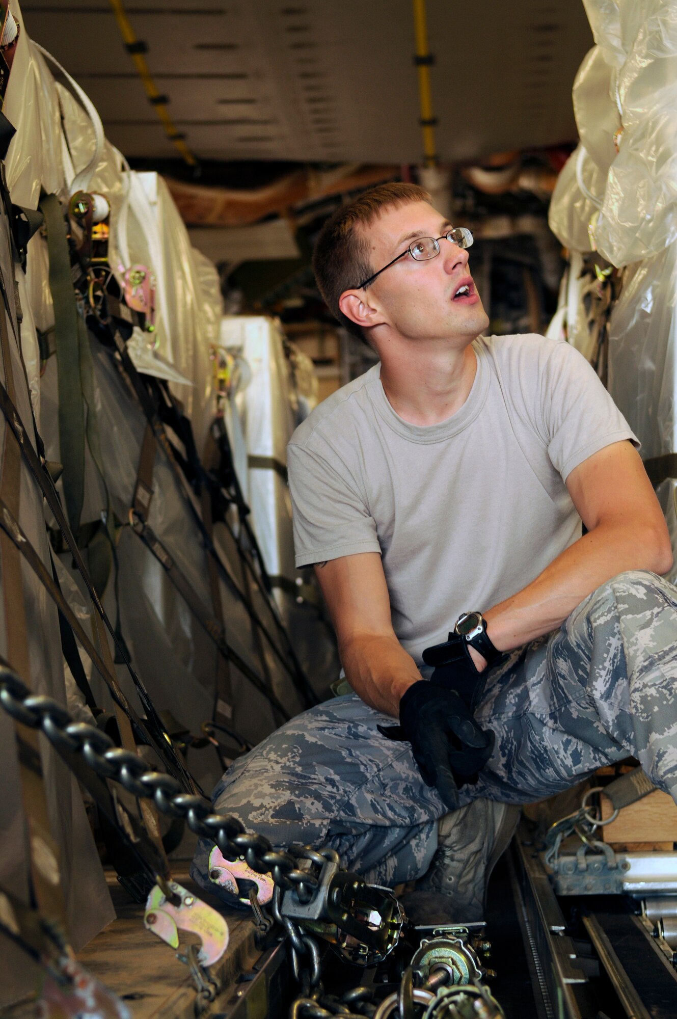 Staff Sgt. Tristan Walder, a 728th Air Mobility Squadron aerial porter, discusses proper tie-down procedures after loading a C-17 Globemaster III May 27, 2009, on the Incirlik Air Base flightline.  Incirlik is a major hub for cargo destined for operational bases in and around the Middle East.  The 728th "Port Dawgs" moved roughly 16 percent of Air Mobility Command's cargo last year.  (U.S. Air Force photo/Staff Sgt. Raymond Hoy)