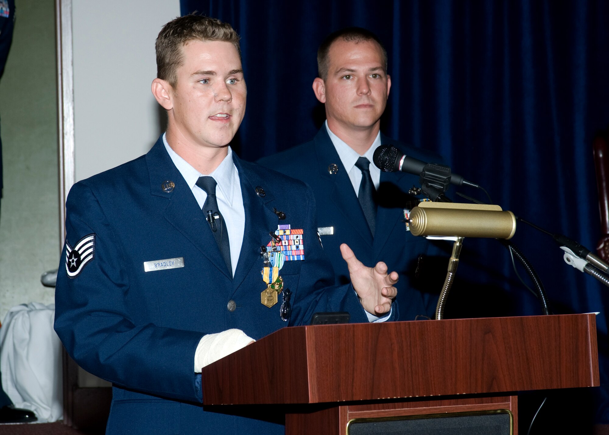 Staff Sgt. Nick Bradley, 96th Security Forces Squadron, addresses the crowd during his retirement ceremony May 21 at Eglin Air Force Base.  Sergeant Bradley was wounded when an improvised explosive device exploded near his vehicle as he was serving with a convoy traveling in Afghanistan. The blast caused facial fractures, a fractured foot, traumatic right arm injuries and amputation of a finger on his left hand.  Sergeant Bradley received a Purple Heart and the Combat Action Medal from Air Force Chief of Staff Gen. Norton Schwartz in October 2008, before being medically retired.  (U.S. Air Force photo/Bruce Hoffman.)