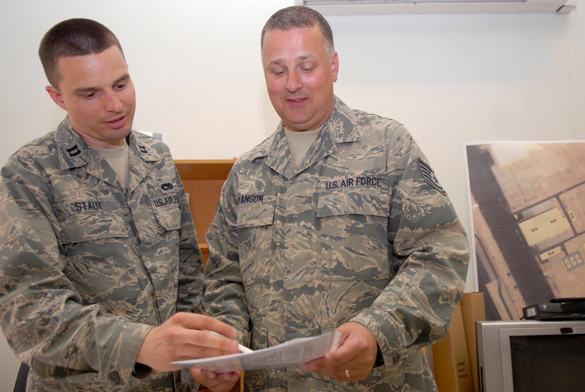 Captain Andrew Staut, the 379th Expeditionary Maintenance Operations Squadron (EMOS) 746th Aircraft Maintenance Unit Officer in Charge, is briefed by Tech. Sgt. Jeff Evanson, a 379th EMOS C-130 Scheduler, on the weekly maintenance schedule, May 27, 2009, at an undisclosed location in Southwest Asia.  The EMOS Plans and Scheduling unit arranges the maintenance on the unit's aircraft.  Capt. Staut hails from Blaine, Minn.  Sergeant Evanson hails from Sparta, Wis.  Both are deployed from the 934th Airlift Wing Air Reserve Station, Minn., in support of Operations Iraqi and Enduring Freedom and Combined Joint Task Force - Horn of Africa.  (U.S. Air Force photo/Senior Airman Andrew Satran/released)