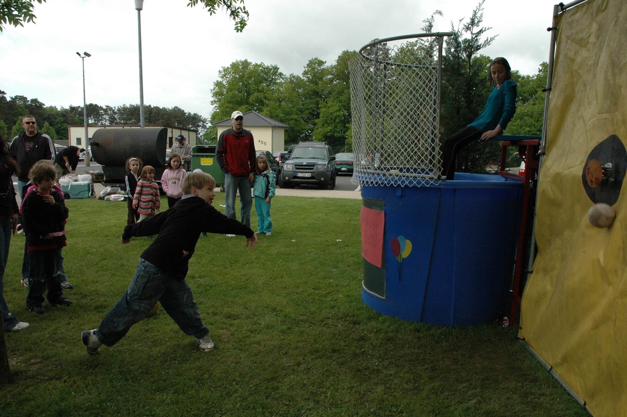 SPANGDAHLEM AIR BASE, Germany -- Asia Rodriguez looks on as Jordan Liebig narrowly misses the target to drop her into the dunking booth May 16, 2009 at the Spangdahlem Elementary School Parent-Teacher-Student Association Spring Carnival. (Photo by Bobbie Gonzales)