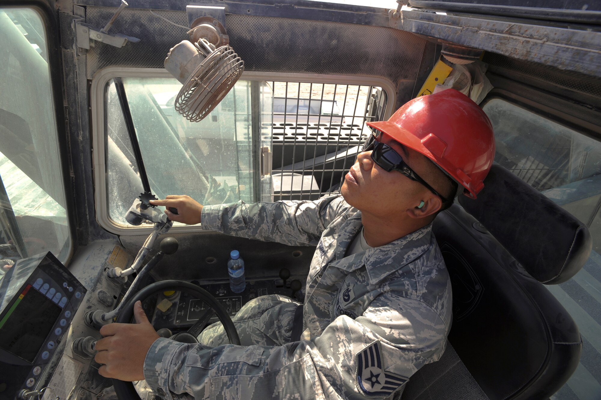 Staff Sgt. Rene Macapagal, a heavy equipment operator with the 379th Expeditionary Civil Engineer Squadron, operates a 60 ton crane to remove an air compressor from a building here, May 26, 2009 in an undisclosed location in Southwest Asia. The crane allows members of the 379th ECES to move large equipment items in a safe manner.  Sergeant Macapagal is native to Honolulu, Hawaii and is deployed from Travis Air Force Base, Calif. in support of Operations Iraqi and Enduring Freedom and Combined Joint Task Force - Horn of Africa.  (U.S. Air Force Photo by Staff Sgt. Joshua Garcia/released)
