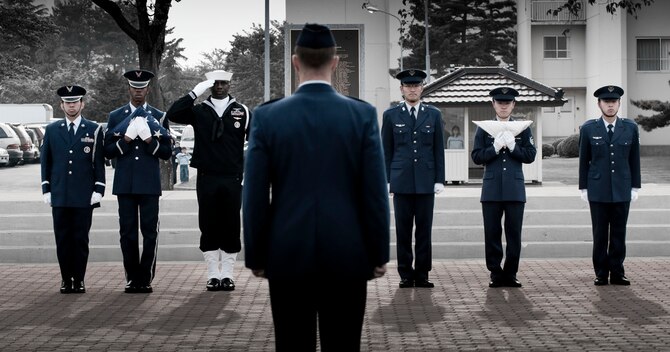 MISAWA AIR BASE, Japan -- A combined joint honor guard presents the American and Japanese flags to Col. RC Craig, 35th Fighter Wing vice commander, May 21, 2009. The Japanese Air Self-Defense Force participated in the ceremony as well to pay their respects in honor of Memorial Day. (U.S. Air Force photo illustration by Staff Sgt. Samuel Morse)