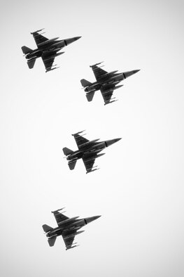 MISAWA AIR BASE, Japan -- Four F-16 Fighting Falcons perform a low-altitude flyby over Risner Circle May 21, 2009. One of the four jets broke off into a missing man formation in honor of pilots who have lost their lives in the past. (U.S. Air Force photo by Staff Sgt. Samuel Morse)