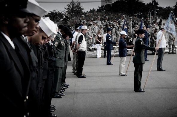 MISAWA AIR BASE, Japan -- Military and civilian attendees at the Memorial Day retreat ceremony bow their heads in an opening prayer May 21, 2009. Representatives of the Navy, Army, Air Force, Japan Air Self-Defense Force, as well as retirees, participated in formations to honor their fallen comrades. (U.S. Air Force photo illustration by Staff Sgt. Samuel Morse)