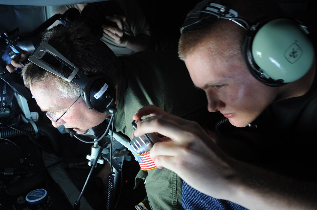 Staff Sgt. Brian Thompson, 509th Expeditionary Aircraft Maintenance Squadron low observerables technician, takes a photo out the boom operator’s window in the back of a KC-135 Stratotanker on May 12.  The Indianapolis, Ind., native, is deployed here to Andersen Air Force Base, Guam, from Whiteman AFB, Mo.  (U.S. Air Force photo by Senior Airman Christopher Bush)