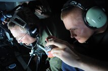 Staff Sgt. Brian Thompson, 509th Expeditionary Aircraft Maintenance Squadron low observerables technician, takes a photo out the boom operator’s window in the back of a KC-135 Stratotanker on May 12.  The Indianapolis, Ind., native, is deployed here to Andersen Air Force Base, Guam, from Whiteman AFB, Mo.  (U.S. Air Force photo by Senior Airman Christopher Bush)