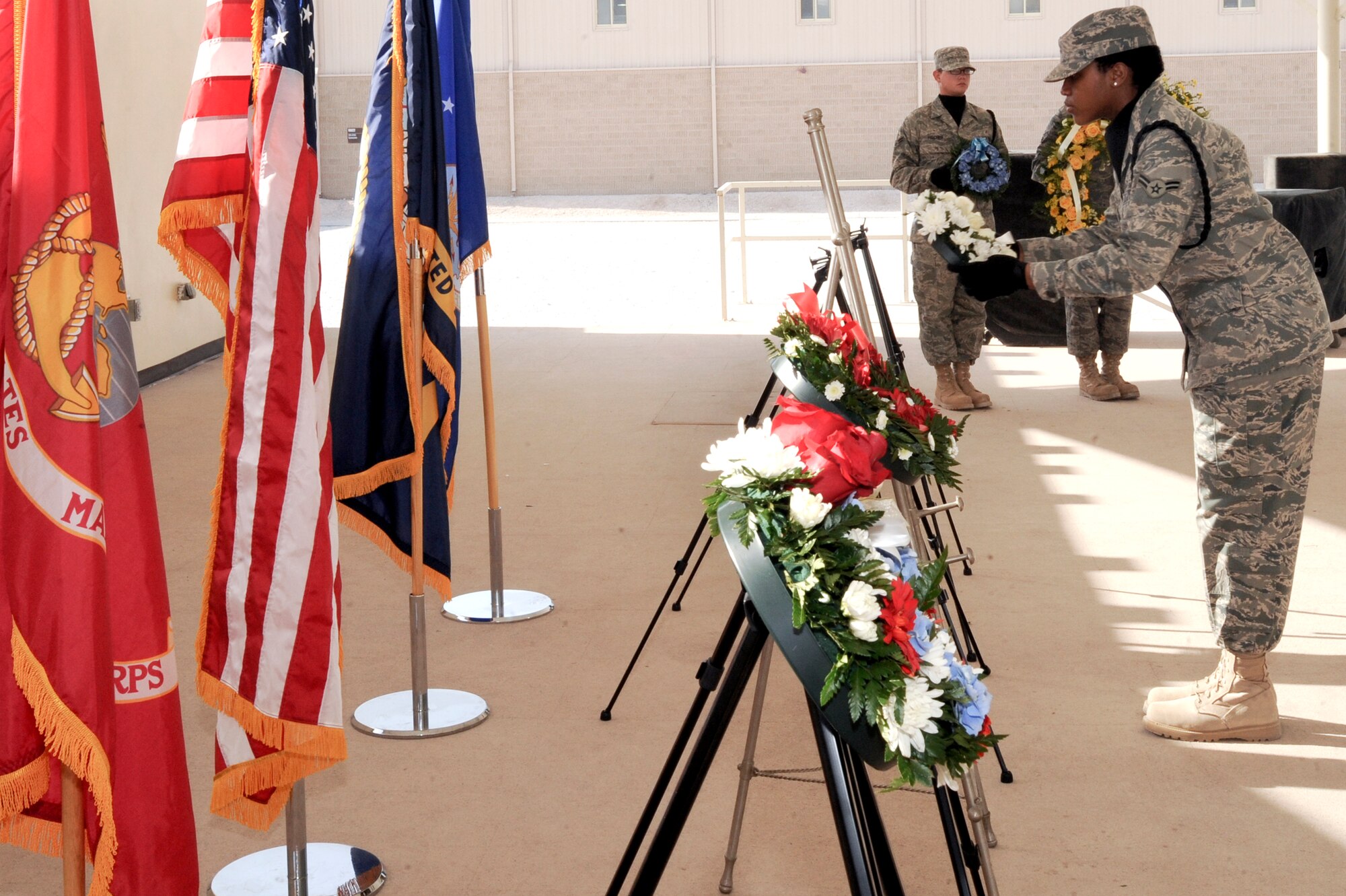 Airman 1st Class, Kadine Powell, a member of the 379th Air Expeditionary Wing Base Honor Guard team, places a wreath during a Memorial Day Wreath Laying Ceremony, May 25, 2009, in and undisclosed location in Southwest Asia.  A wreath was laid for each service and the Department of Defense to remember and honor all those who have died in service to the United States. Airman Powell is native to Queens, N.Y. and is deployed from Canon Air Force Base, N.M., in support of Operations Iraqi and Enduring Freedom and Combined Joint Task Force - Horn of Africa.  (U.S. Air Force Photo by Staff Sgt. Joshua Garcia/released)