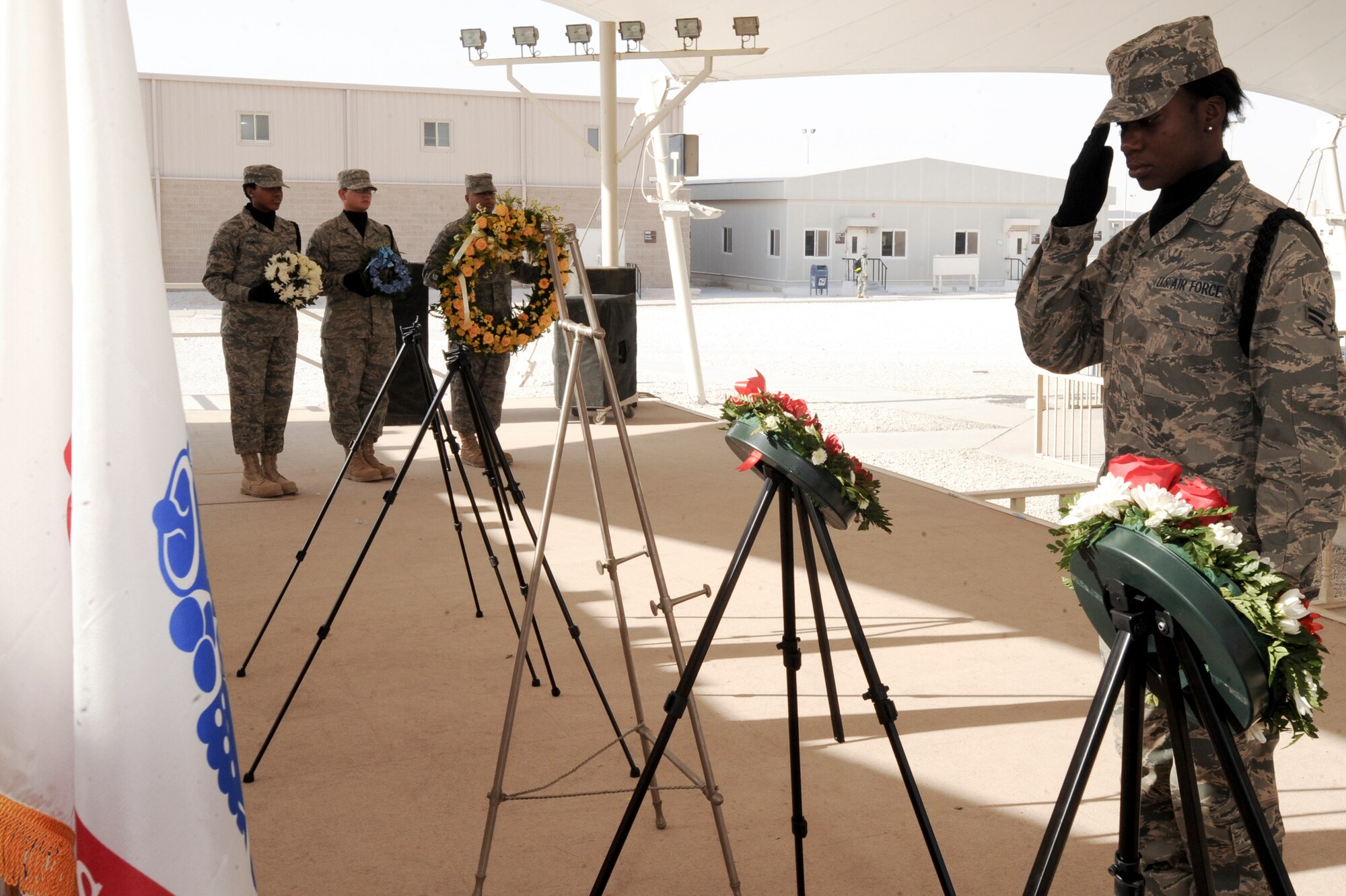 Airman 1st Class Ayoka Francis, a member of the 379th Air Expeditionary Wing Base Honor Guard team, salutes the Marine Corps wreath during a Memorial Day Wreath Laying Ceremony held here May 25, 2009 in and undisclosed location in Southwest Asia.  A wreath was laid for each service and the Department of Defense to remember and honor all those who have died in service to the United States. Airman Francis is native to Stroudsburg, Penn. and is deployed from Canon Air Force Base, N.M. in support of Operations Iraqi and Enduring Freedom and Combined Joint Task Force - Horn of Africa.  (U.S. Air Force Photo by Staff Sgt. Joshua Garcia/released)