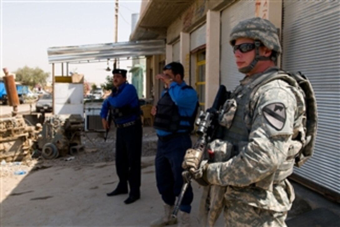 U.S. Army Pfc. Joshua Manley, a cavalry scout attached to Crazy horse Troop, 4th Squadron, 9th Cavalry Regiment, 2nd Heavy Brigade Combat Team, 1st Cavalry Division provides security during a combined reconnaissance patrol with counterparts of the Iraqi Police in the industrial sector of the town of Taza, in Kirkuk, Iraq, on May 16, 2009.
