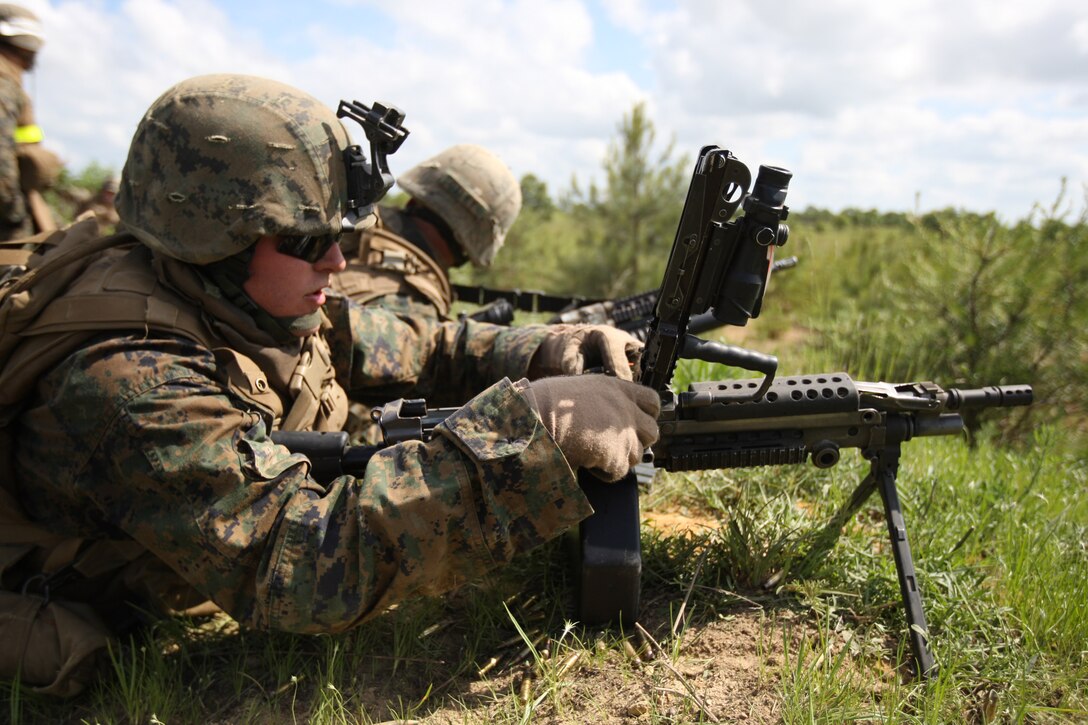 A M-249 squad automatic weapon gunner with second platoon, Company I, 3rd Battalion, 6th Marine Regiment, 2nd Marine Division, places rounds on the feed tray during a company attack during Exercise A.P. Hill, which took place May 18 through June 4.