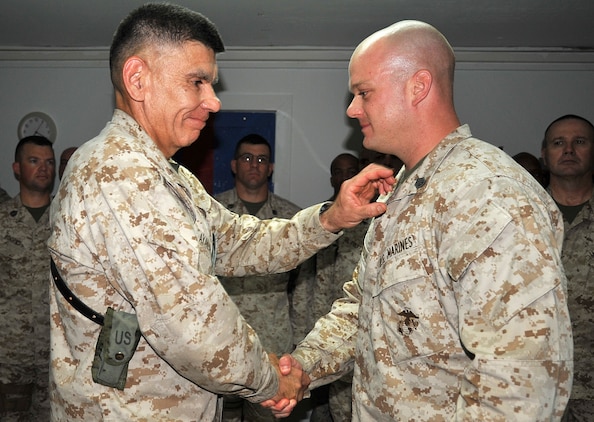 Brig. Gen. Juan G. Ayala, commanding general, 2nd Marine Logistics Group (Forward), congratulates then Staff Sgt. Jason Eckman after his promotion to gunnery sergeant May 2, 2009 at the Tun Tavern meeting facility aboard Camp Al Taqaddum, Iraq.  Eckman attributes his successes throughout his Marine Corps career to the numerous experiences that have given him the tools and drive to achieve his goals along the way.