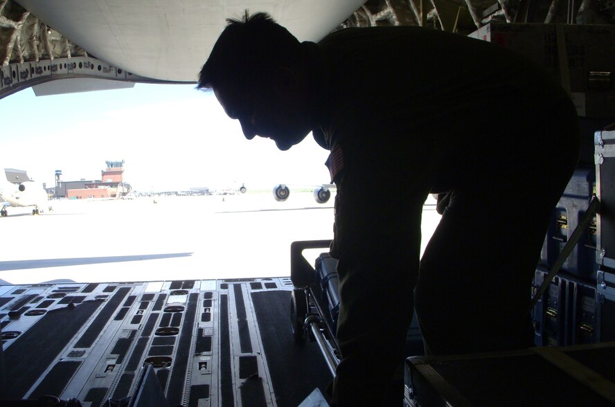 Master Sgt. Chris Anthony, 15th Airlift Squadron loadmaster, works to secure communication equipment used by staffers of Vice President Joseph Biden May 27 at Peterson Air Force Base, Colo. Vice President Biden attended and spoke at the U.S. Air Force Academy's graduation, where fourth-year cadets received not only their degree, but their commissions as second lieutenants in the U.S. Air Force. Sergeant Anthony, a loadmaster on C-17 Globemaster IIIs, is based at Charleston AFB in South Carolina. (U.S. Air Force photo/Senior Airman Stephen J. Collier)