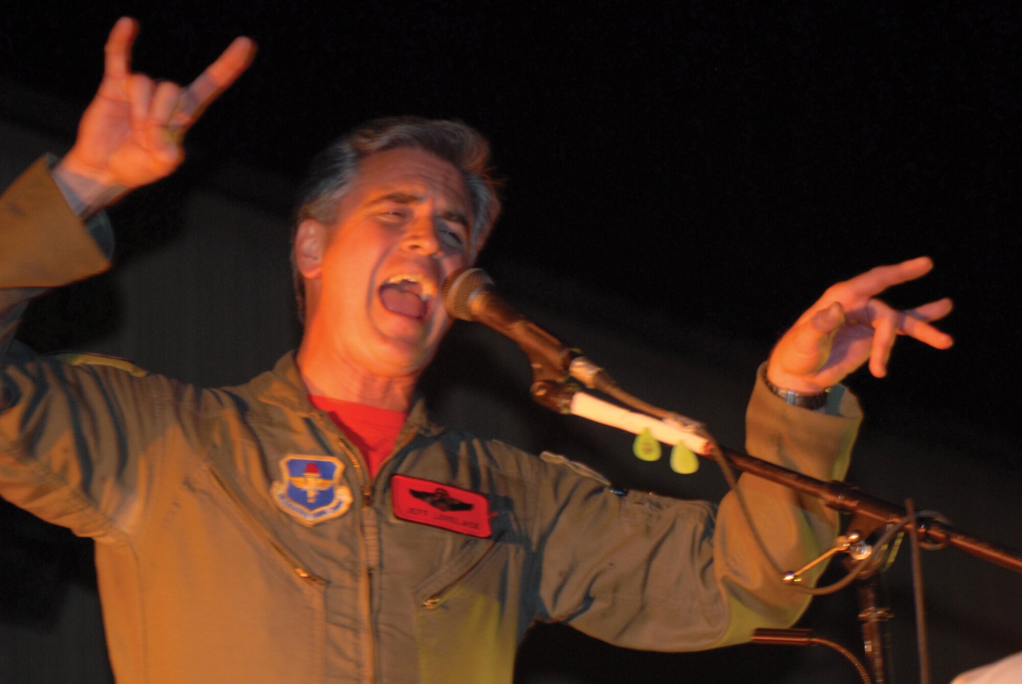 Lt. Col. Jeffrey Lovelace, 56th Fighter Wing director of staff and rock star, sings with the band Steal Wool during the 63rd Fighter Squadron stand down and Cactus Starfighter Squadron realignment block party held in front of Bldg. 903. U.S. Air Force photo/ Airman 1st Class Sandra Welch)