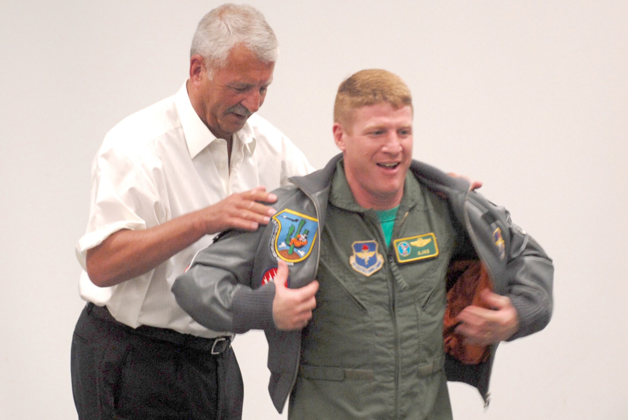 Retired German air force Lt. Gen. Peter Vogler presents Lt. Col. James McCune, 310th Fighter Squadron commander, with a jacket on behalf of the Cactus Starfighter Squadron.(U.S. Air Force photo/ Airman 1st Class Sandra Welch)