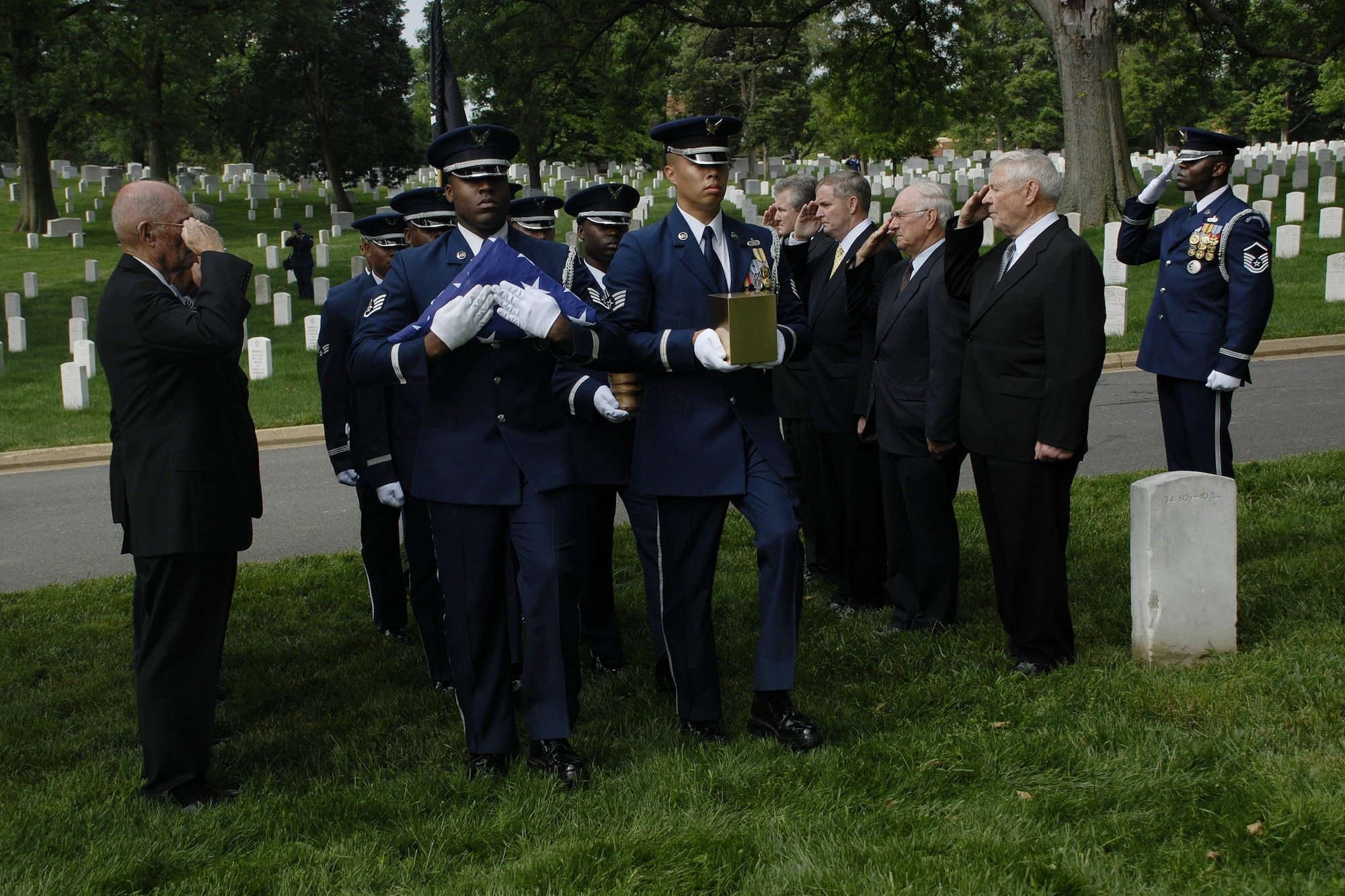 U.S. Air Force Honor Guard members position the remains of Chief Master Sergeant Paul W. Airey while former Chief Master Sergeant's of the Air Force render salutes during the memorial service at Arlington National Cemetery, Va., May 28. Chief Airey, serving 27 years, became the first Chief Master Sergeant of the Air Force April 3, 1967, following his installment by then Secretary of the Air Force Harold Brown and Air Force Chief of Staff Gen. John P. McConnell. Chief Airey retired from active duty on Aug. 1, 1970 and died March 11 in Panama City, Fla. Chief Airey and his wife Shirley's remains were buried together at Arlington National Cemetery. (U.S. Air Force photo/Master Sgt. Stan Parker) 