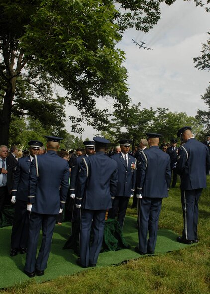 U.S. Air Force Honor Guard members position the remains of Chief Master Sergeant Paul W. Airey, while a B-52 Stratofortress from Barksdale Air Force Base, La., performs a flyover manuever, during the memorial service at Arlington National Cemetery, Va., May 28. Chief Airey, serving 27 years, became the first Chief Master Sergeant of the Air Force April 3, 1967, following his installment by then Secretary of the Air Force Harold Brown and Air Force Chief of Staff Gen. John P. McConnell. Chief Airey retired from active duty on Aug. 1, 1970 and died March 11 in Panama City, Fla. Chief Airey and his wife Shirley's remains are buried together at Arlington National Cemetery. (U.S. Air Force photo/Master Sgt. Stan Parker) 