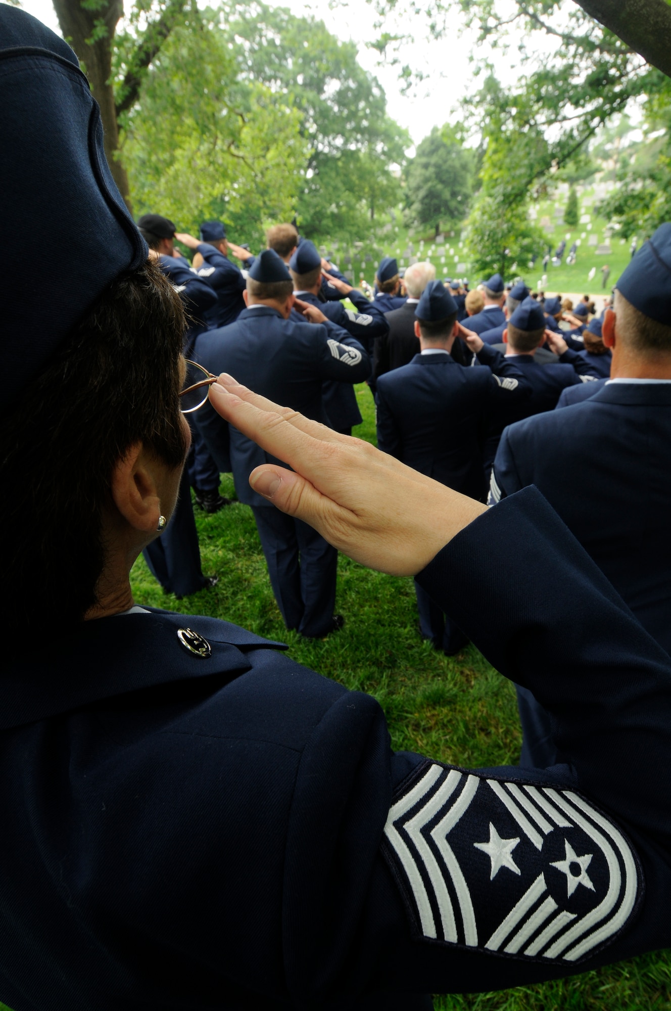 A command chief master sergeant salutes during the during funeral proceedings for former Chief Master Sgt. of the Air Force Paul W. Airey, May 28, at Arlington National Cemetery in Arlington, Va. Former CMSAF Airey was adviser to Secretary of the Air Force Harold Brown and Chief of Staff of the Air Force Gen. John P. McConnell on matters concerning welfare, effective utilization and progress of the enlisted members of the Air Force.  Former CMSAF Airey was the first chief master sergeant appointed to this ultimate noncommissioned officer position and was selected from among 21 major air command nominees to become the first chief master sergeant of the Air Force. (U.S. Air Force photo by Staff Sgt. Dan DeCook)