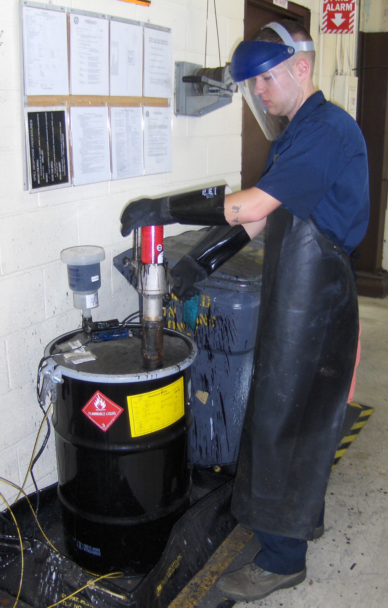Airman 1st Class Gregor Nolan, 96th Logistics Readiness Squadron, is puncturing an aerosol can to make it safe for recycling.  Proper disposal of hazard waste is a small part of the Environmental and Occupational Health, Compliance Assessment and Management Program inspection at Eglin.  EOHCAMP is the Air Force's annual self-assessment tool that helps commanders check the status of environmental and occupational health compliance to state and federal environmental laws, and Air Force polices, and to identify and track solutions to known problem areas.  (U.S. Air Force photo/Beth Avery.)
