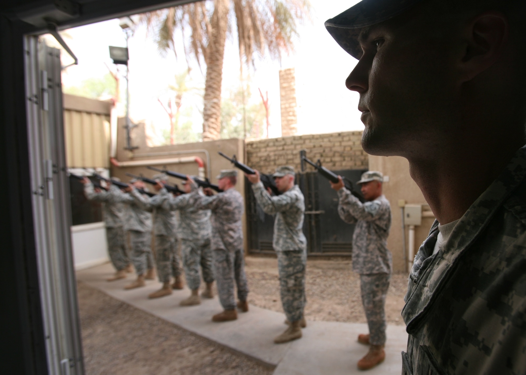 BAGHDAD, Iraq --  A seven riflemen team rendered military honors by firing three volleys at the May 28 memorial for Cmdr. Duane Wolfe in Baghdad, Iraq. Sgt. Maj. Paul Yingst, in the foreground, served as the non-commissioned officer in charge of the rifle team. (USACE photo courtesy of F.T. Eyre)