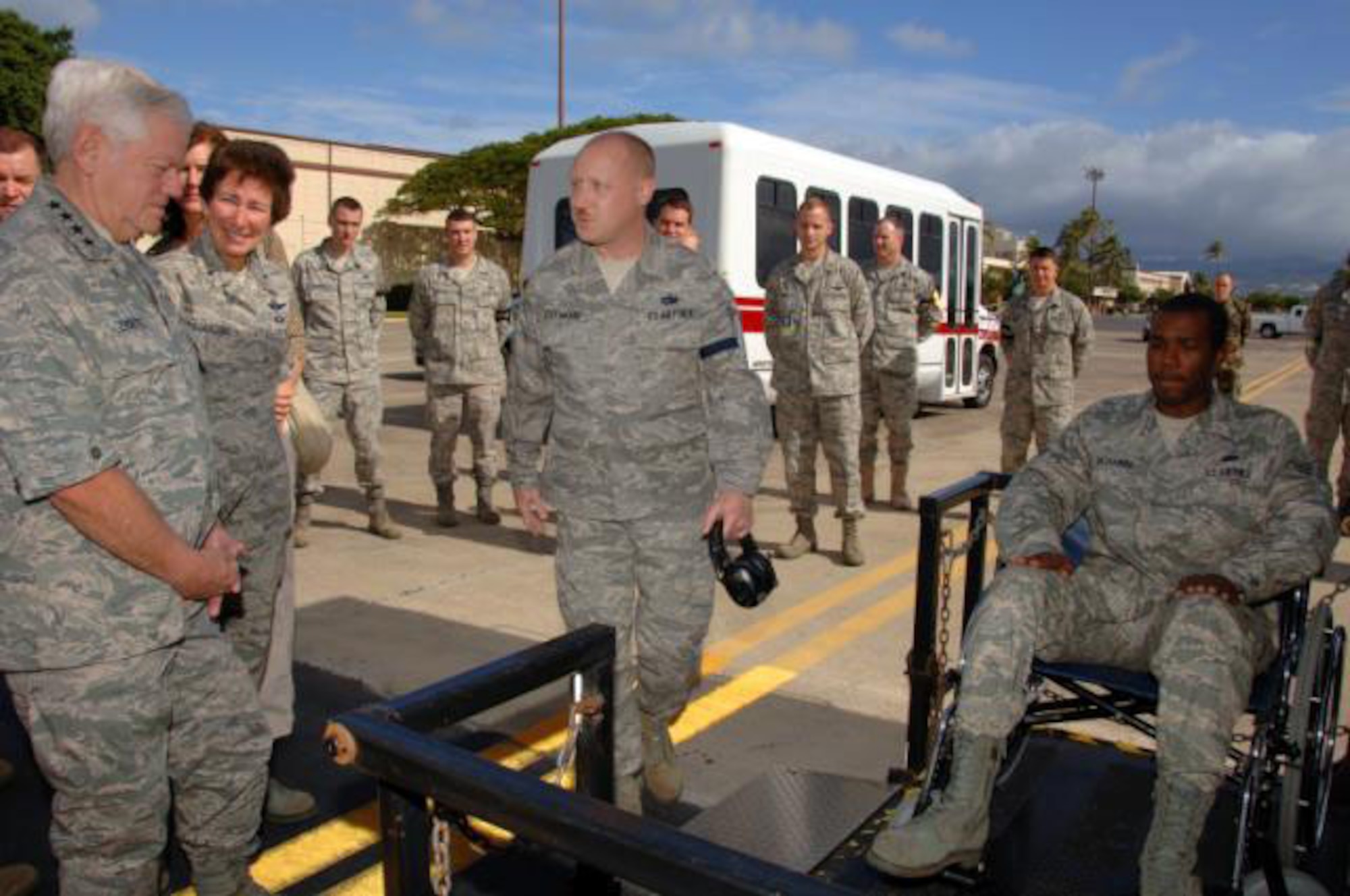 Tech. Sgt. Scott Lockwood, briefs Gen. Arthur Lichte, Air Mobility Command commander, on the aeromedical mission applications of a highlift truck while Senior Airman Tyrone Richards simulates a patient load via wheelchair at Hickam Air Force Base, Hawaii.  The general was visiting the base to meet with the Airmen of the 735th Air Mobility Squadron in February. The 735th AMS is part of the 515th Air Mobility Operations Wing, which celebrated its one-year anniversary June 5. (Courtesy photo)  
