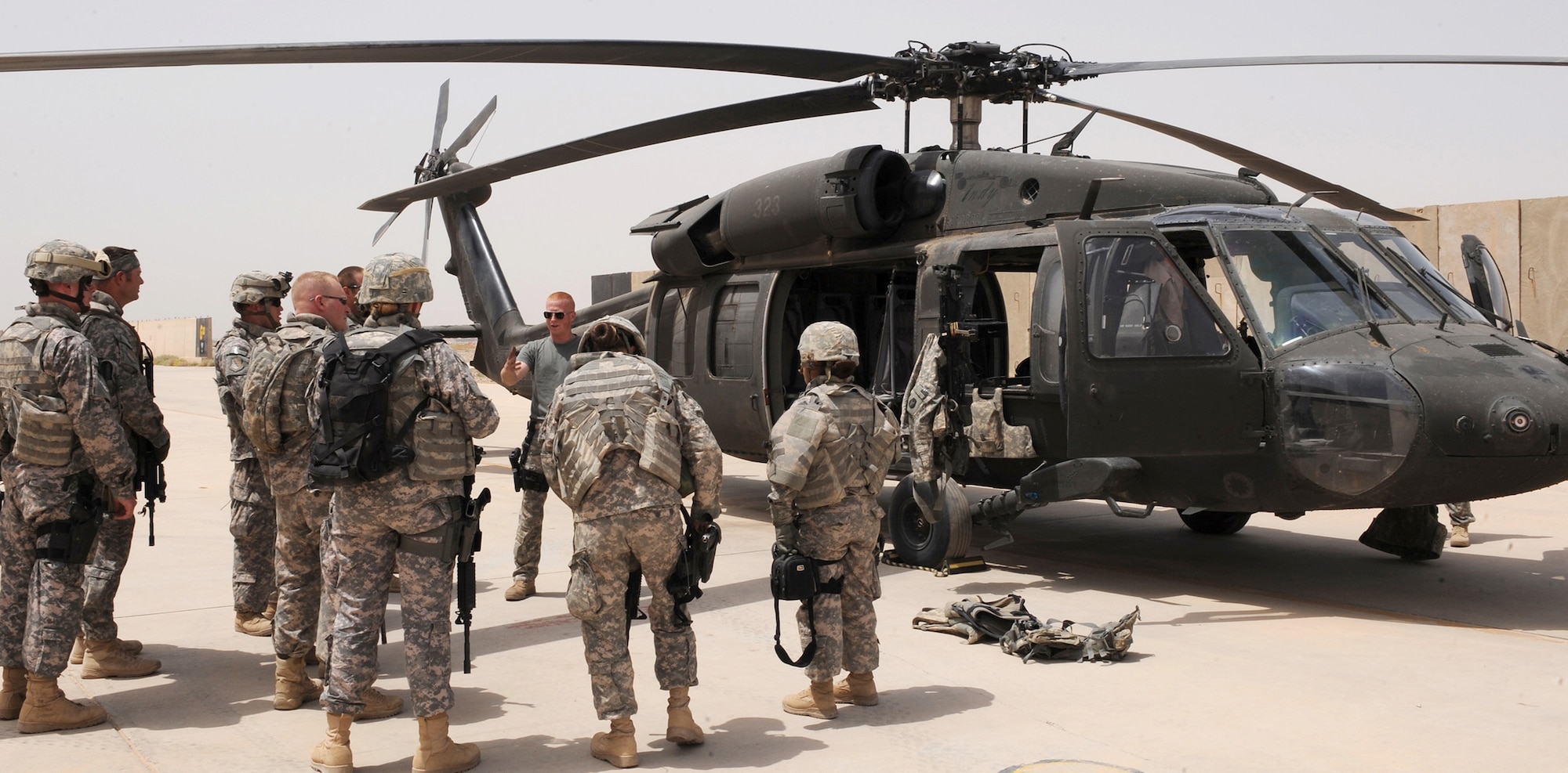 Airmen from the 532nd Expeditionary Security Forces Squadron's quick reaction force team go over their training mission before boarding an Army helicopter from the C Company, 1-137th Aviation Regiment May 23 at Joint Base Balad, Iraq. Airmen trained on egress, ingress and setting up security for the helicopter. Members of the 532nd ESFS QRF are often called "outside the wire" to investigate indirect-fire attacks. (U.S. Air Force photo/Senior Airman Tiffany Trojca) 
