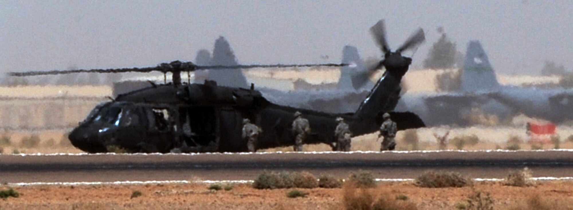 Airmen from the 532nd Expeditionary Security Forces Squadron's quick reaction force ingress an Army helicopter from C Company, 1-137th Aviation Regiment, during air-assault training May 23 at Joint Base Balad, Iraq. The Airmen trained on egress, ingress and setting up security for the helicopter. Members of the 532nd ESFS QRF are often called "outside the wire" to respond to indirect-fire attacks. (U.S. Air Force photo/Senior Airman Tiffany Trojca) 