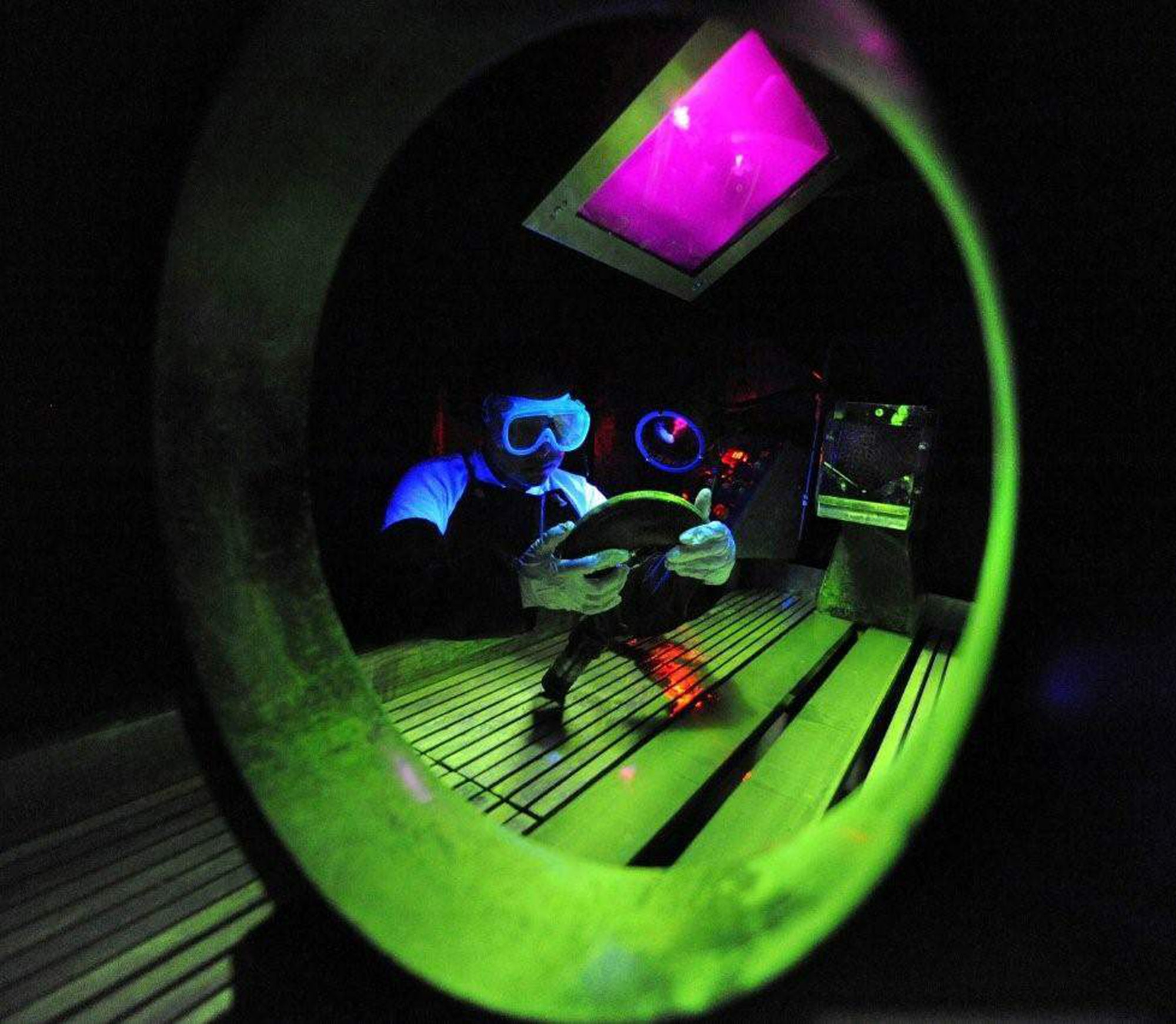 Senior Airman Lilia Linares uses a fluorescent magnetic particle process to inspect an aerospace ground equipment hook for cracks May 27 at Charleston Air Force Base, S.C. The nondestructive inspection section inspects more than 40,000 pieces of weapon systems and nonweapon systems assets a year. Airman Linares is a nondestructive inspection journeyman with the 437th Maintenance Squadron. (U.S. Air Force photo/James M. Bowman)