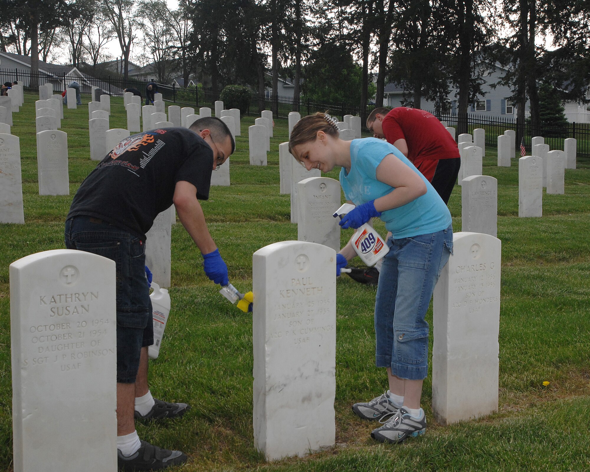 OFFUTT AIR FORCE BASE, Neb. - Senior Airman Kyle M. Kent, 55th Communications Squadron Network Control Center administration technician, and his wife Ashley clean a headstone inside the Offutt Cemetery in preparation for Offutt's Memorial Day ceremony May 25. U.S. Air Force photo by Leticia Cunningham 