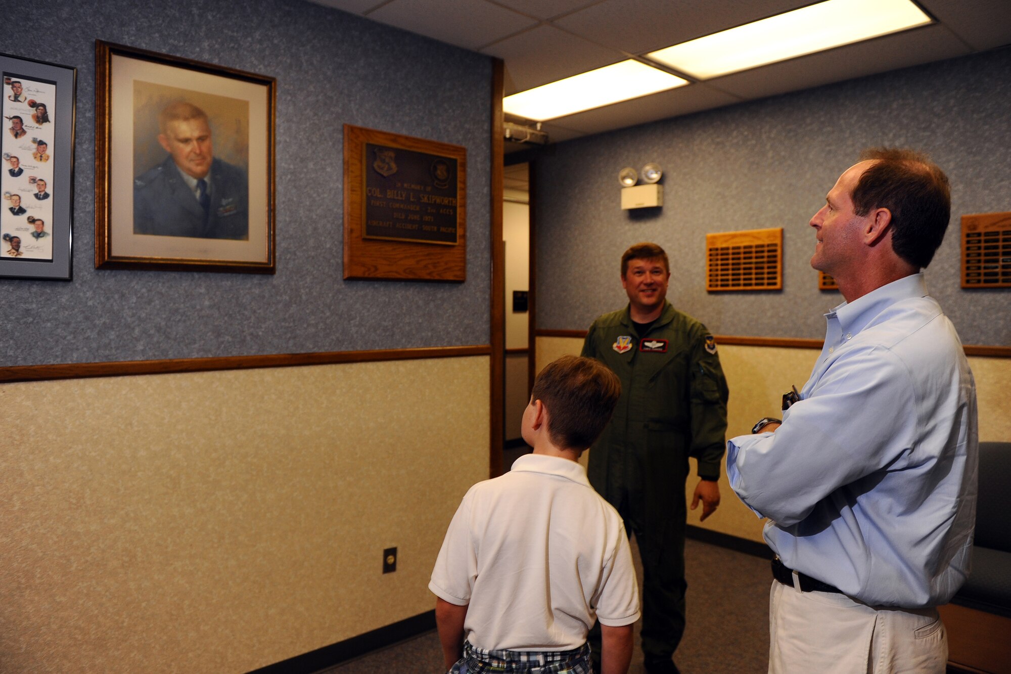OFFUTT AIR FORCE BASE, Neb. ? Lt Col. Chris L. Canada, 55th Wing director of staff, shows Timothy K. Skipworth and his son William, a painting of Timothy's father, Col. Billy L. Skipworth, during a tour of the Billy L. Skipworth Operations Center here May 23. Col. Skipworth was the commander of the 2nd Airborne Command and Control Squadron and the building was named after him upon after he died in a Boeing EC-135N crash in the South pacific on June 13, 1971. Timothy was 8-years-old when his father died. The visit was his first to Offutt since he was a young boy. U.S. Air Force Photo by Josh Plueger
