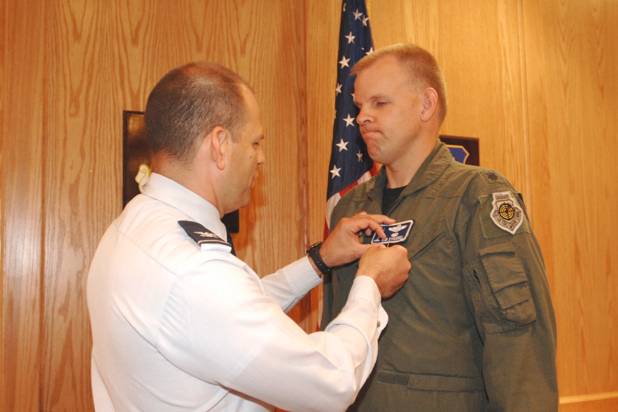 MCCONNELL AIR FORCE BASE, Kan. -- Col. James C. Vechery, 22nd Air Refueling Wing commander, pins the meritorious service medal on Lt. Col. Robert Stroebel, former chief of wing safety, May 27. Colonel Stroebel received this award for his time as chief of wing safety and his action deployed. The Meritorious Service Medal is awarded to any member of the armed forces of the United States who distinguishes himself by either outstanding achievement or meritorious service to the United States. (Photo by Staff Sgt. Jamie Train)
