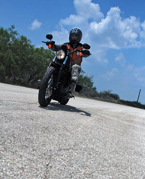 LAUGHLIN AIR FORCE BASE, Texas – Second Lt. Geraldo Garza, a casual lieutenant working at the education center here, takes all the necessary safety measures while driving a motorcycle on base here May 27. During the 101 Critical Days of Summer base leadership urge all Airmen to exercise safe practices and make sound judgments this summer. See story page 3. (U.S. Air Force photo by Airman 1st Class Sara Csurilla)



