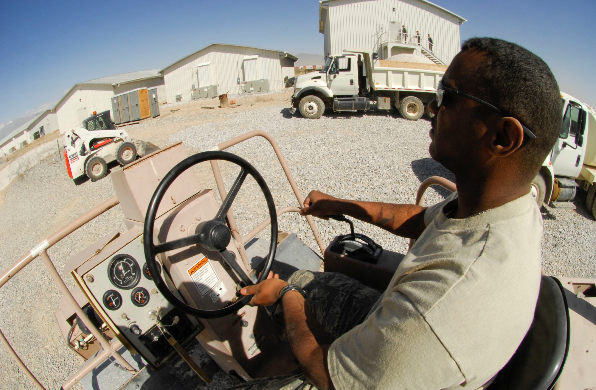 BAGRAM AIR FIELD, Afghanistan- Tech. Sgt. Darryl Guppy, 455th Expeditionary Civil Engineer Squadron, drives a roller to flatten out the area for a concrete foundation to be poured here May 27. The foundation will be used to extend an A-10 aircraft hangar for alert crews. Sergeant Guppy hails from Brooklyn, N.Y., and is deployed from the Community College of the Air Force at Gunter Annex, Ala. (U.S. Air Force photo/Senior Erik Cardenas) 