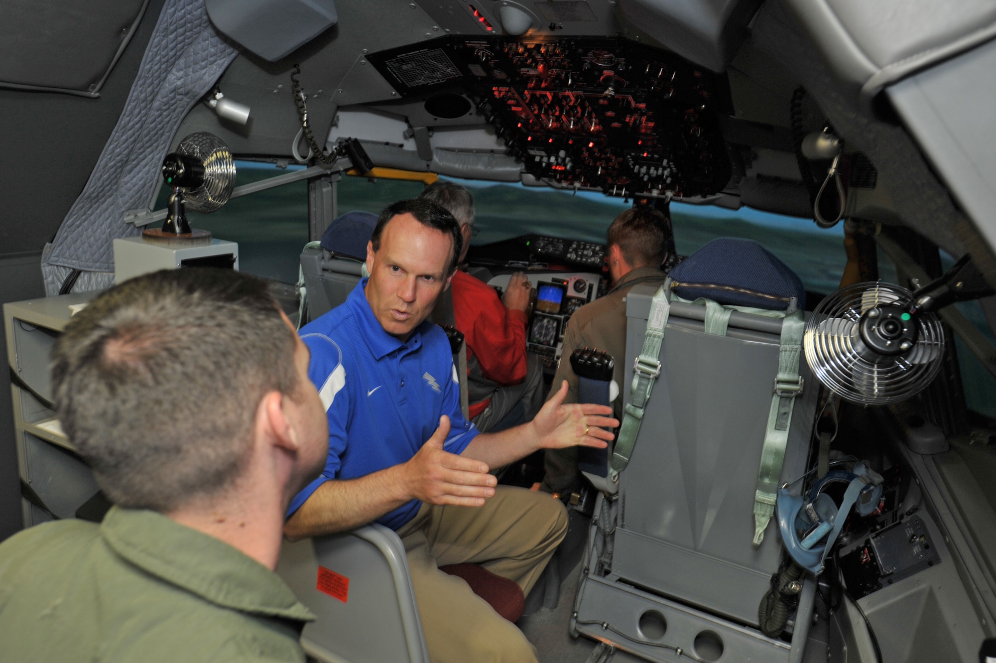 Troy Calhoun, head football coach at the Air Force Academy, talks to a KC-135 Stratotanker pilot while Jim Tressel, head football coach at Ohio State University, learns how to fly inside a KC-135 simulator at McConnell Air Force Base, Kan., on May 27. The coaches were visiting the base at the start of Coaches Tour 2009, a morale-boosting mission that allows icons of college football to interact with U.S. servicemembers. (U.S. Air Force photo/Tech. Sgt. Jason Schaap)