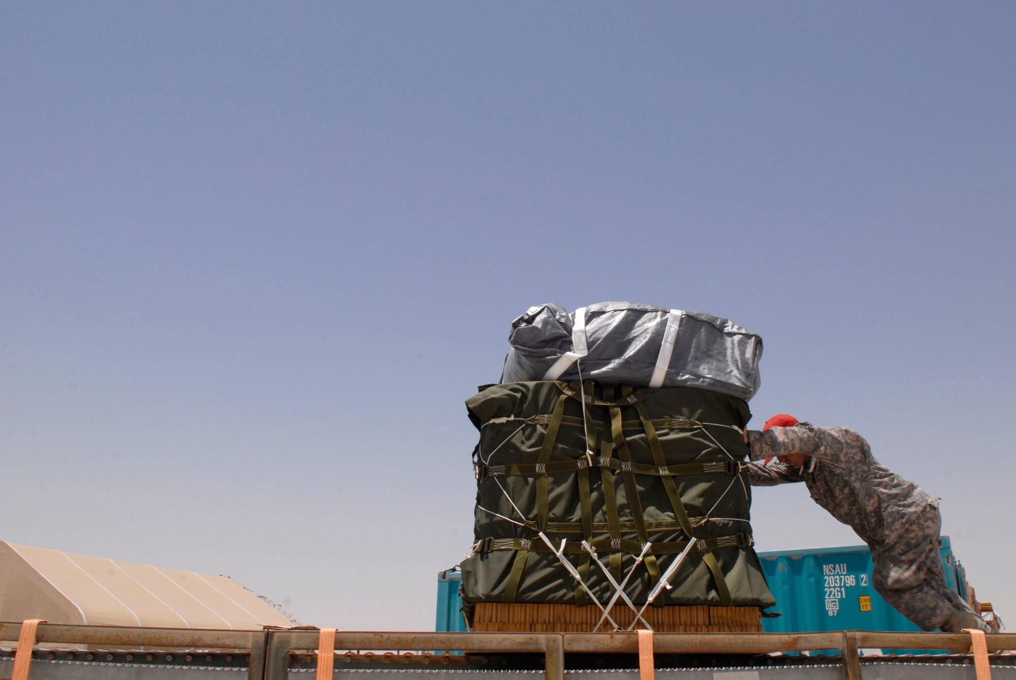 U.S. Army Sergeant Josh Sheptock, an 824th Quartermaster Det 7 Rigger, loads a bundle of JP-8 fuel and gasoline onto a trailer, May 27, 2009, at an undisclosed location in Southwest Asia.  The fuel drums are specially packed by the riggers for the drop from a C-17 Globemaster III to forward operating locations in the U.S. Central Command's Area of Responsibility.  Sergeant Sheptock hails from Fayetteville, N.C. and is deployed from Fort Bragg, N.C., in support of Operations Iraqi and Enduring Freedom and Combined Joint Task Force - Horn of Africa.  (U.S. Air Force photo/Senior Airman Andrew Satran/released)   