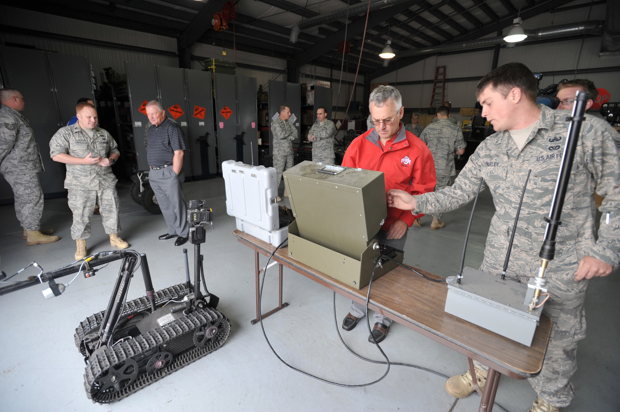 Senior Airman Eric Farley shows Jim Tressel, head football coach at Ohio State University, how to remotely control a robot used during explosive ordnance disposal missions. Airman Farley, native of Fayette, Ala., is assigned to an EOD unit at McConnell Air Force Base, Kan., where Tressel and two other coaches--Troy Calhoun of Air Force and Jim Grobe of Wake Forest--visited at the start of a morale-boosting mission called Coaches Tour 2009. (U.S. Air Force photo/Tech. Sgt. Jason Schaap)