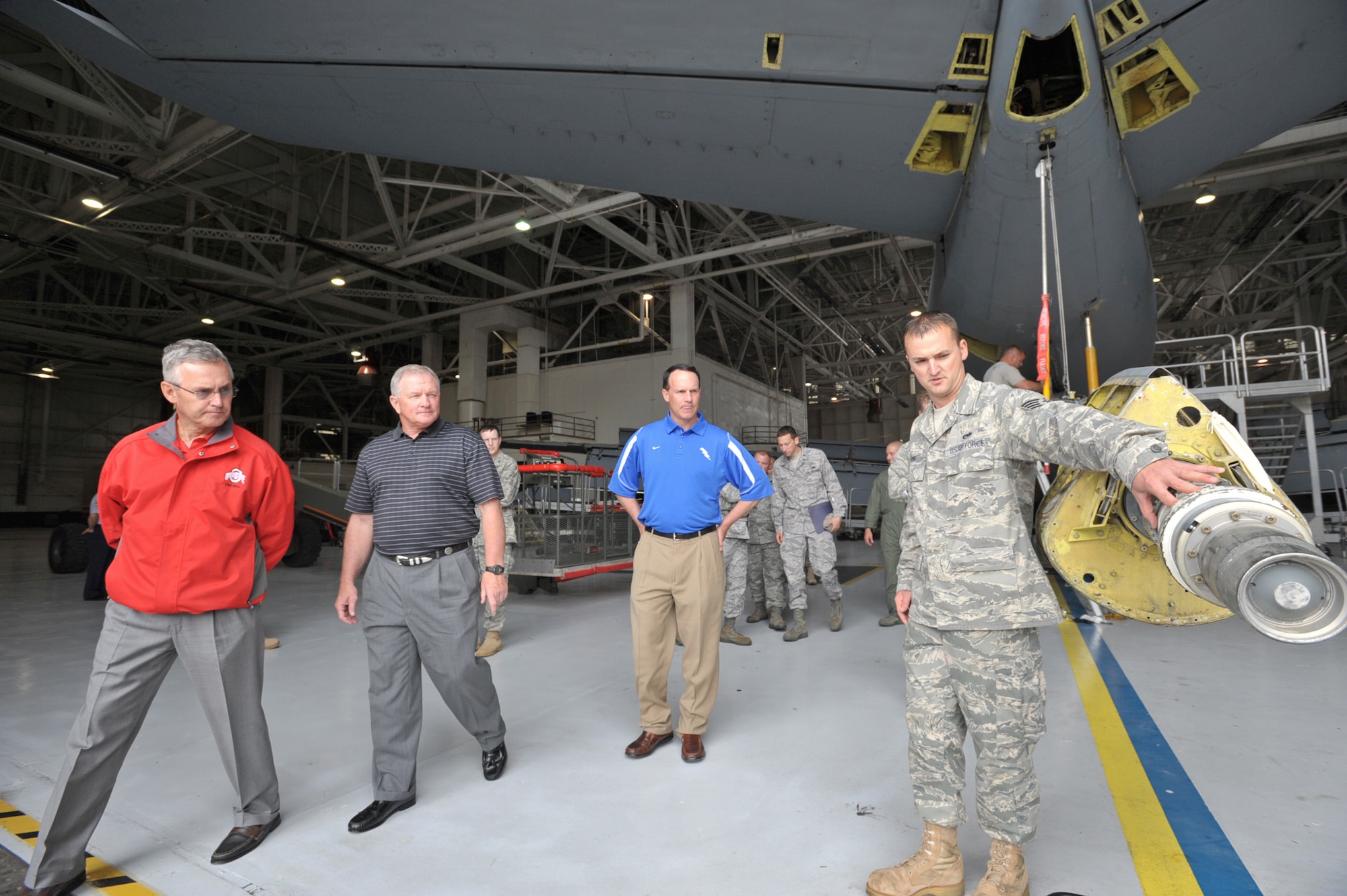 Three NCAA football coaches--(from left to right) Jim Tressel of Ohio State, Jim Grobe of Wake Forest, and Troy Calhoun of Air Force--listen to Staff Sgt. James Long talk about the boom of a KC-135 Stratotanker at McConnell Air Force Base, Kan., on May 27. The coaches visited different units at the base to start Coaches Tour 2009, a second annual morale-boosting mission that allows U.S. servicemembers to interact with icons of college football. Sergeant Long is a KC-135 hyrdraulics technician assigned to the 22nd Air Refueling Wing at McConnell. (U.S. Air Force photo/Tech. Sgt. Jason Schaap)