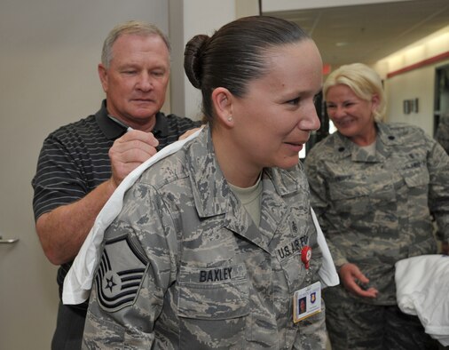 Master Sgt. Tarah Baxley offers Jim Grobe, head football coach at Wake Forest University, a writing surface in exchange for his autograph at McConnell Air Force Base, Kan., on May 27. Coach Grobe visited the base at the start of Coaches Tour 2009, a second annual morale-boosting mission that allows college football icons to interact with U.S. servicemembers. Sergeant Baxley is a medical lab technician assigned to the 22nd Air Refueling Wing at McConnell and a native of Caribou, Maine. (U.S. Air Force photo/Tech. Sgt. Jason Schaap)
