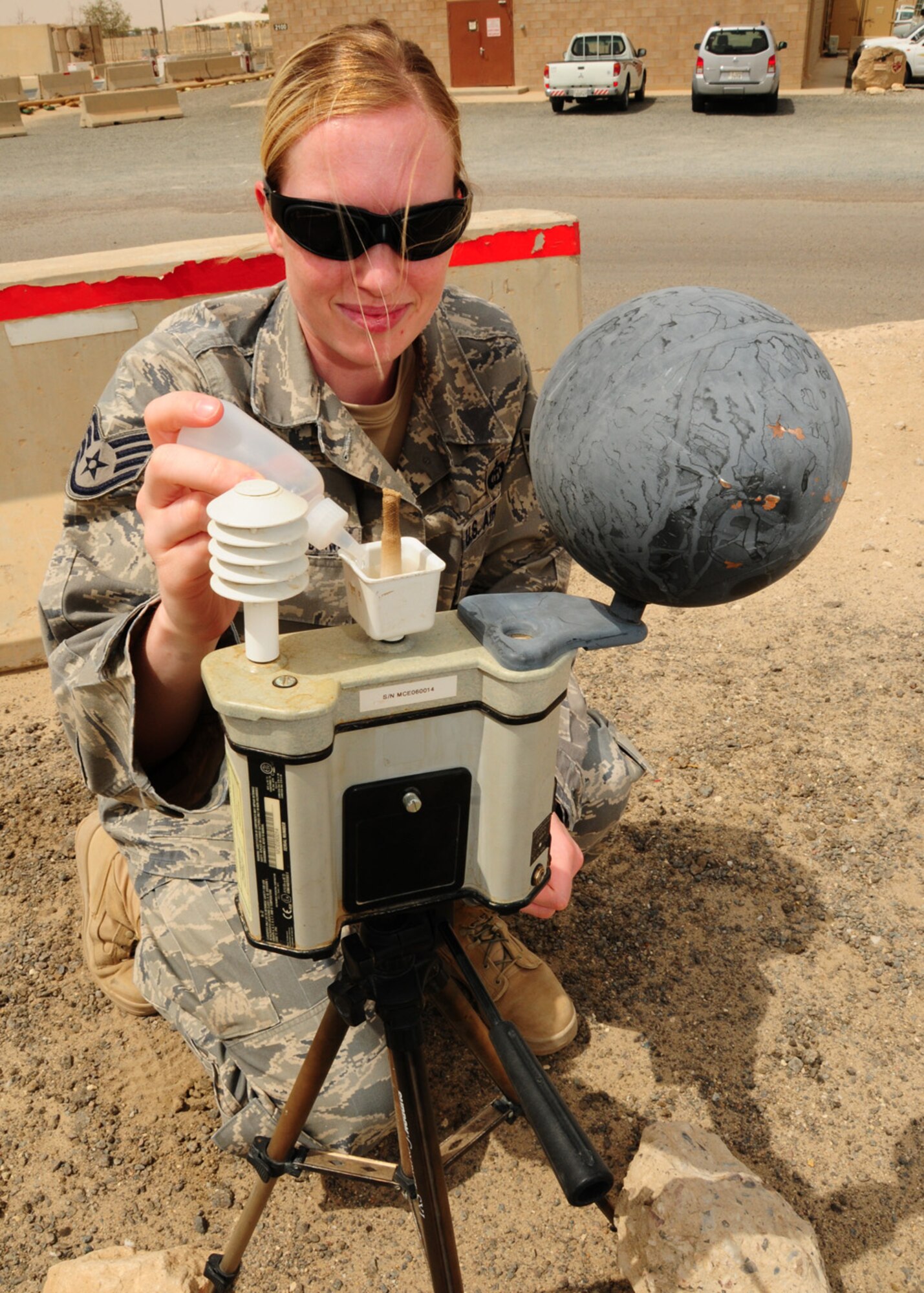 SOUTHWEST ASIA -- Staff Sgt. Stacy Vandenwyngaard, 386th Expeditionary Operations Support Squadron, adds distilled water to the heat stress monitor to ensure accurate Wet Bulb Globe temperature readings. The Wet Bulb Globe Temperature is a composite temperature used to estimate the effect of temperature, humidity, wind speed and solar radiation on humans, determining the heat stress category used for work/rest cycles. Sergeant Vandenwyngaard is currently deployed from Charleston Air Force Base, S.C., and is originally from Appleton, Wis. (U.S. Air Force photo/ Senior Airman Courtney Richardson)