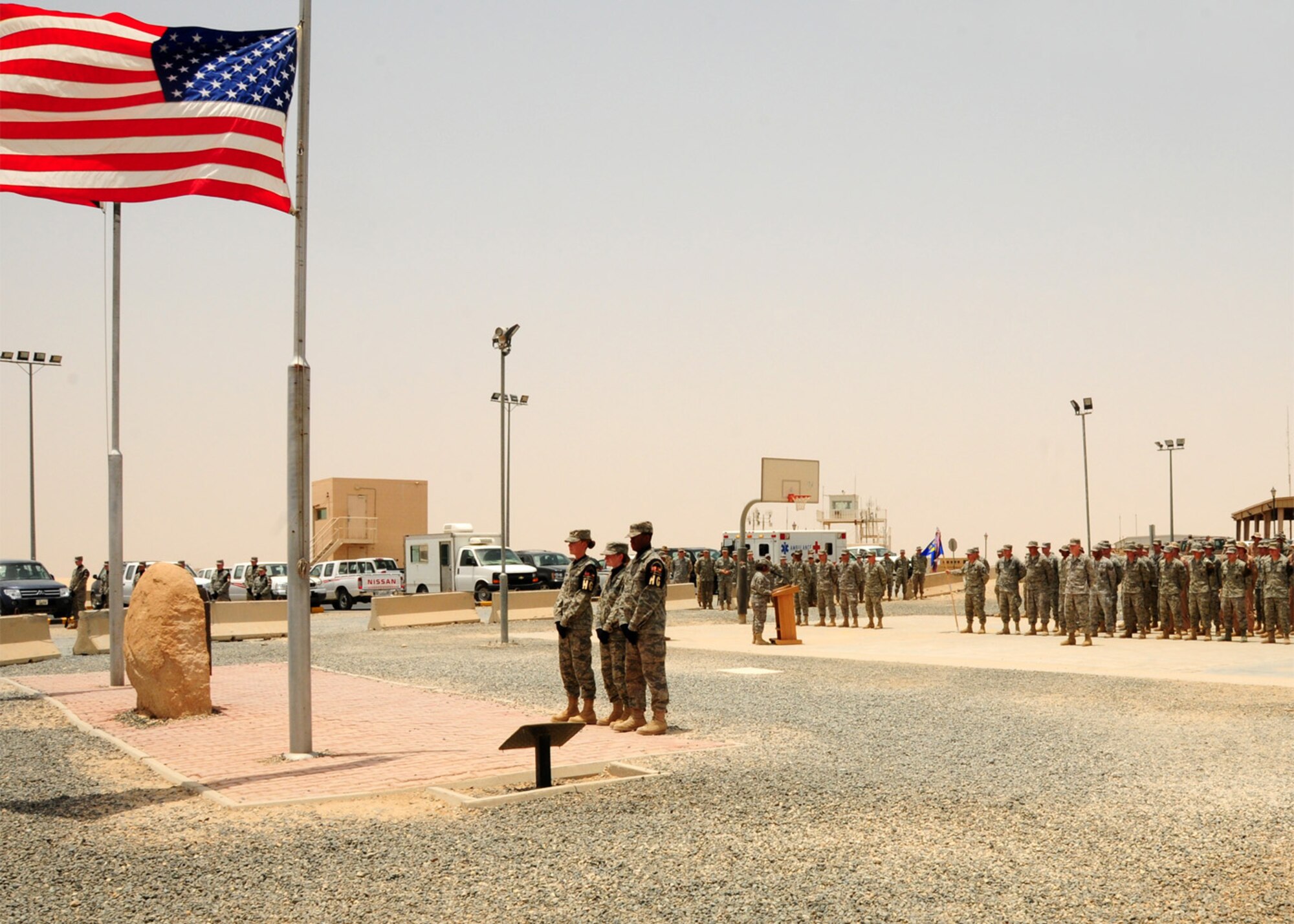 SOUTHWEST ASIA -- Airmen and personnel from the 386th Air Expeditionary Wing stand at attention during the Memorial Day ceremony at an air base in Southwest Asia, May 25. Memorial Day, originally called Decoration Day, is annually on the last Monday in May in the United States in honor of the nation's armed services personnel killed in wartime. (U.S. Air Force photo/ Senior Airman Courtney Richardson)