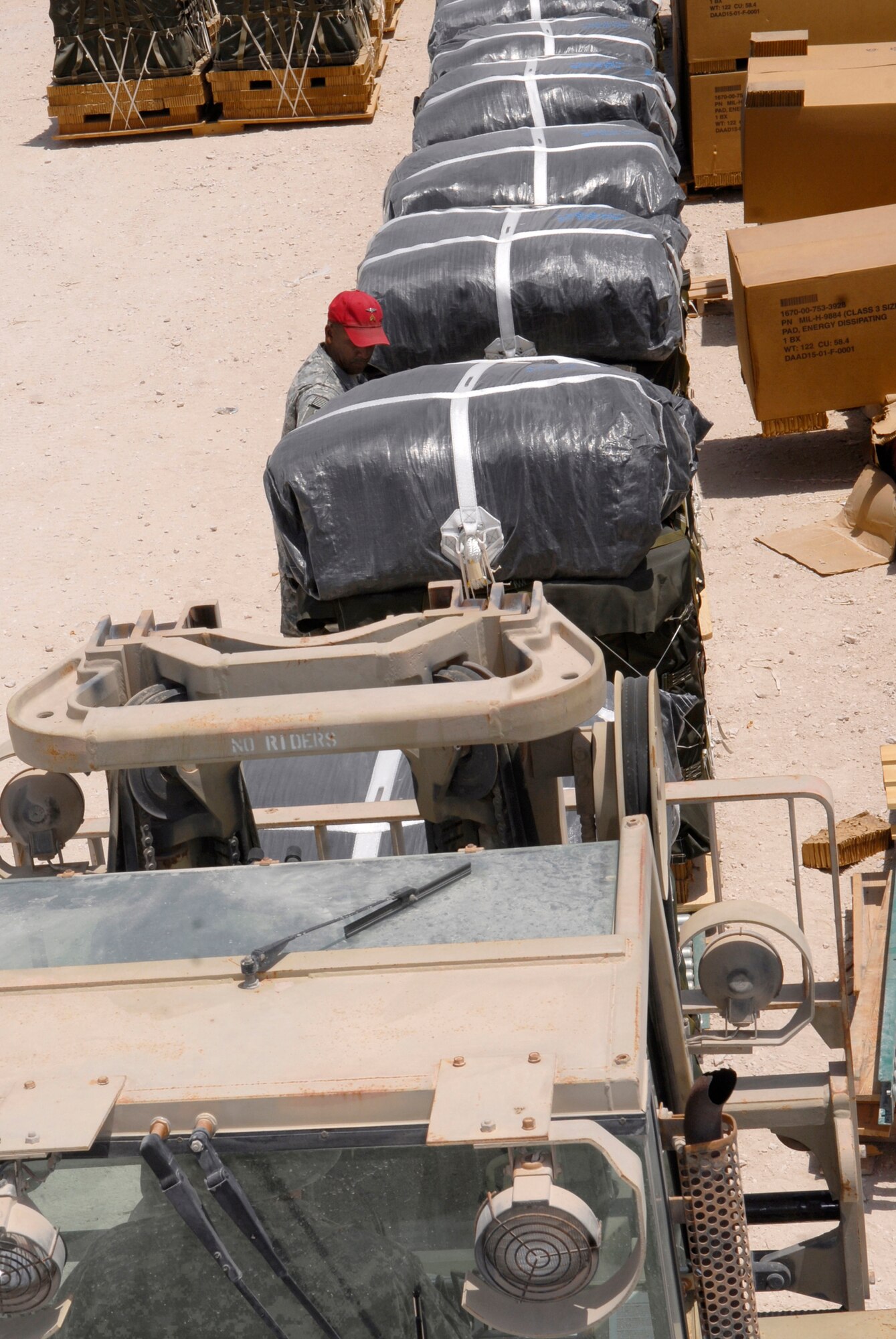 U.S. Army Sergeant Robert McNeely, an 824th Quartermaster (QM) Det 7 Rigger, helps load bundles of JP-8 fuel and gasoline onto a forklift, May 27, 2009, at an undisclosed location in Southwest Asia.  The fuel drums are specially packed by the riggers for the drop from a C-17 Globemaster III to forward operating locations in the U.S. Central Command's Area of Responsibility.  Sergeant McNeely hails from Mooresville, N.C. and is deployed from the 824th QM Det 1 U.S. Army Reserve Station Charlotte, N.C., in support of Operations Iraqi and Enduring Freedom and Combined Joint Task Force - Horn of Africa.  (U.S. Air Force photo/Senior Airman Andrew Satran/released)