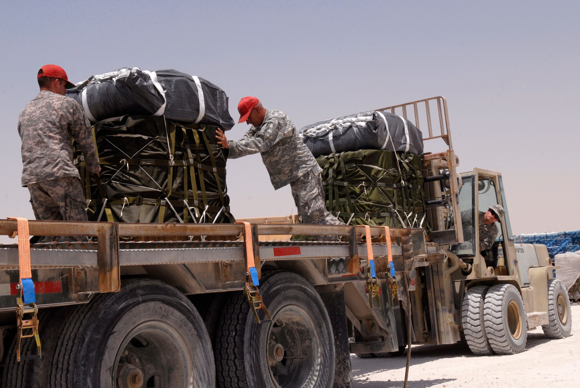 U.S. Army Sergeant Josh Sheptock, an 824th Quartermaster Det 7 Rigger, U.S. Army Chief Warrant Officer Hervy Tyndall, 824th QM Det 7 Commander, and U.S. Army Staff Sergeant Robert McKinney, an 824th QM Det 7 Rigger load bundles of JP-8 fuel and gasoline onto a trailer, May 27, 2009, at an undisclosed location in Southwest Asia.  The fuel drums are specially packed by the riggers for the drop from a C-17 Globemaster III to forward operating locations in the U.S. Central Command's Area of Responsibility.  SGT Sheptock hails from Fayetteville, N.C. and is deployed from Fort Bragg, N.C.  Chief Warrant Officer Tyndall also hails from Fayetteville, N.C. and is deployed from Fort Bragg, N.C.  Staff Sgt. McKinney hails from Hudson, N.C. and is deployed from the 824th Quartermaster Det 1 U.S. Army Reserve Station Charlotte, N.C.  All are deployed in support of Operations Iraqi and Enduring Freedom and Combined Joint Task Force - Horn of Africa.  (U.S. Air Force photo/Senior Airman Andrew Satran/released)   