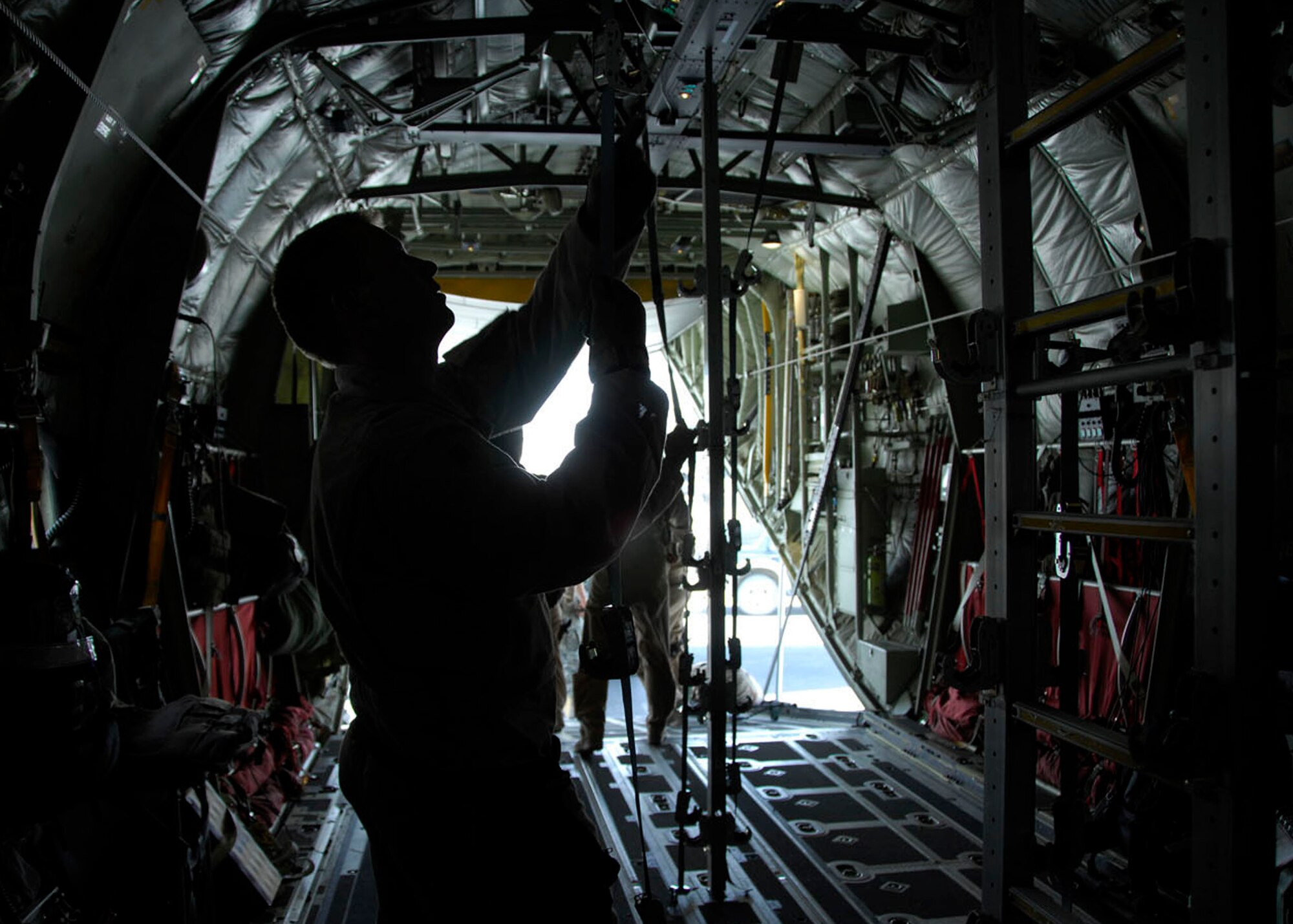 KANDAHAR AIR FIELD, Afghanistan - Master Sgt. Zach Johnson, a 451st Expeditionary Aeromedical Evacuation Flight medical technician, adjusts a litter bracket for loading a patient on a C-130J here, May 22. The 451st EAEF mission is to facilitate and execute fixed-wing patient movement within the Afghanistan theater of operations. Sergeant Johnson is stationed with the 934th Aeromedical Evacuation Squadron in Minneapolis, Minn. and hails from Lund, Wis. (U.S. Air Force photo by 1st Lt. Noelle Caldwell)
