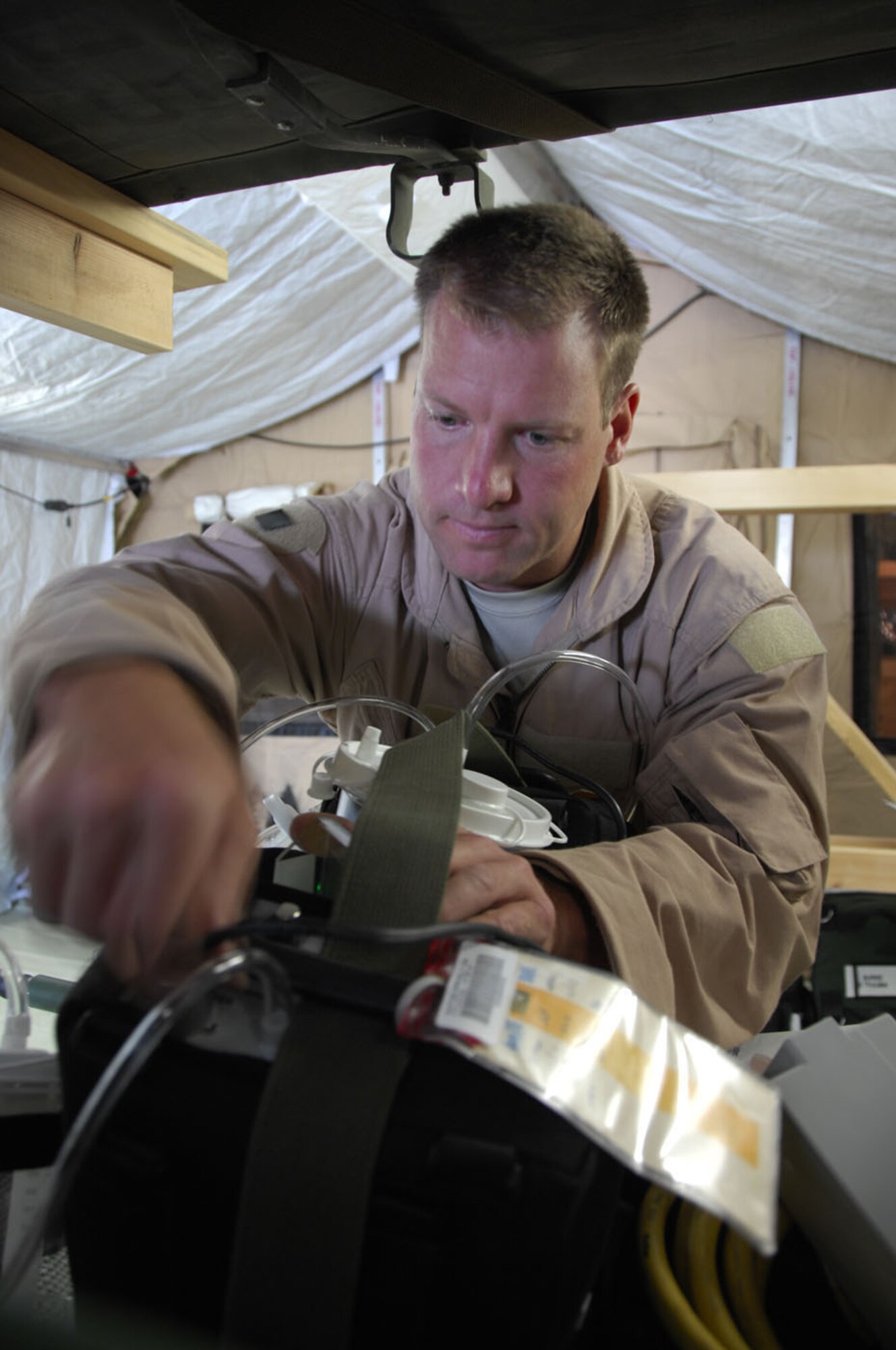 KANDAHAR AIR FIELD, Afghanistan - Master Sgt. Zach Johnson, a 451st Expeditionary Aeromedical Evacuation Flight medical technician, conducts pre-flight checks on medical equipment, May 22, 2009. The 451st EAEF mission is to facilitate and execute fixed-wing patient movement within the Afghanistan theater of operations. Sergeant Johnson is stationed with the 934th Aeromedical Evacuation Squadron in Minneapolis, Minn. and hails from Lund, Wis. (US Air Force photo by 1st Lt. Noelle Caldwell)  
