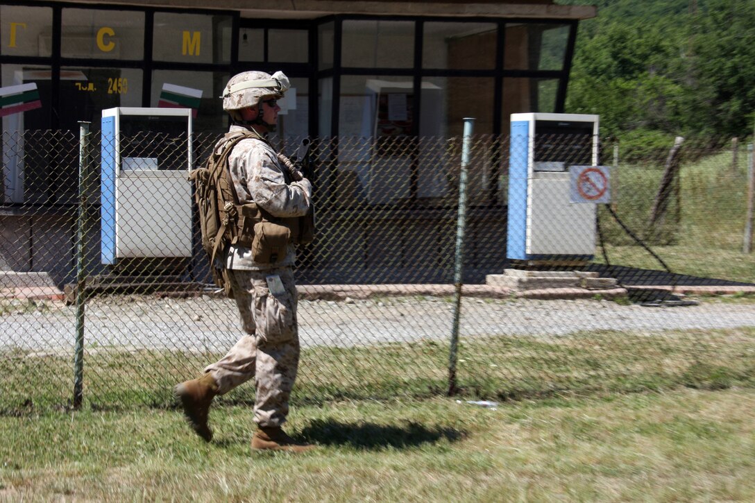 Sgt. John Clapsaddle, a native of Liscomb, Iowa and squad leader with Kilo Company, Battalion Landing Team, 3rd Battalion, 2nd Marine Regiment, 22nd Marine Expeditionary Unit, patrols past a gas station aboard the Nova Selo Training Area in Sliven, Bulgaria May 28, 2009. Kilo Co. Marines are in Bulgaria to conduct training at the joint Bulgarian-American training base. This is the first time U.S. Marines have conducted this kind of training in Bulgaria. The 22nd MEU is currently serving as the theater reserve force for U.S. European Command. (Official Marine Corps photo by Staff Sgt. Matt Epright)