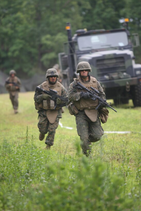 Marines with Headquarters and Service Company, 3rd Battalion, 6th Marine Regiment, 2nd Marine Division, quickly run to reinforce security and evacuate casualties after a simulated suicide bomber attacked the entry control point of the forward operating base during Exercise A.P. Hill.
