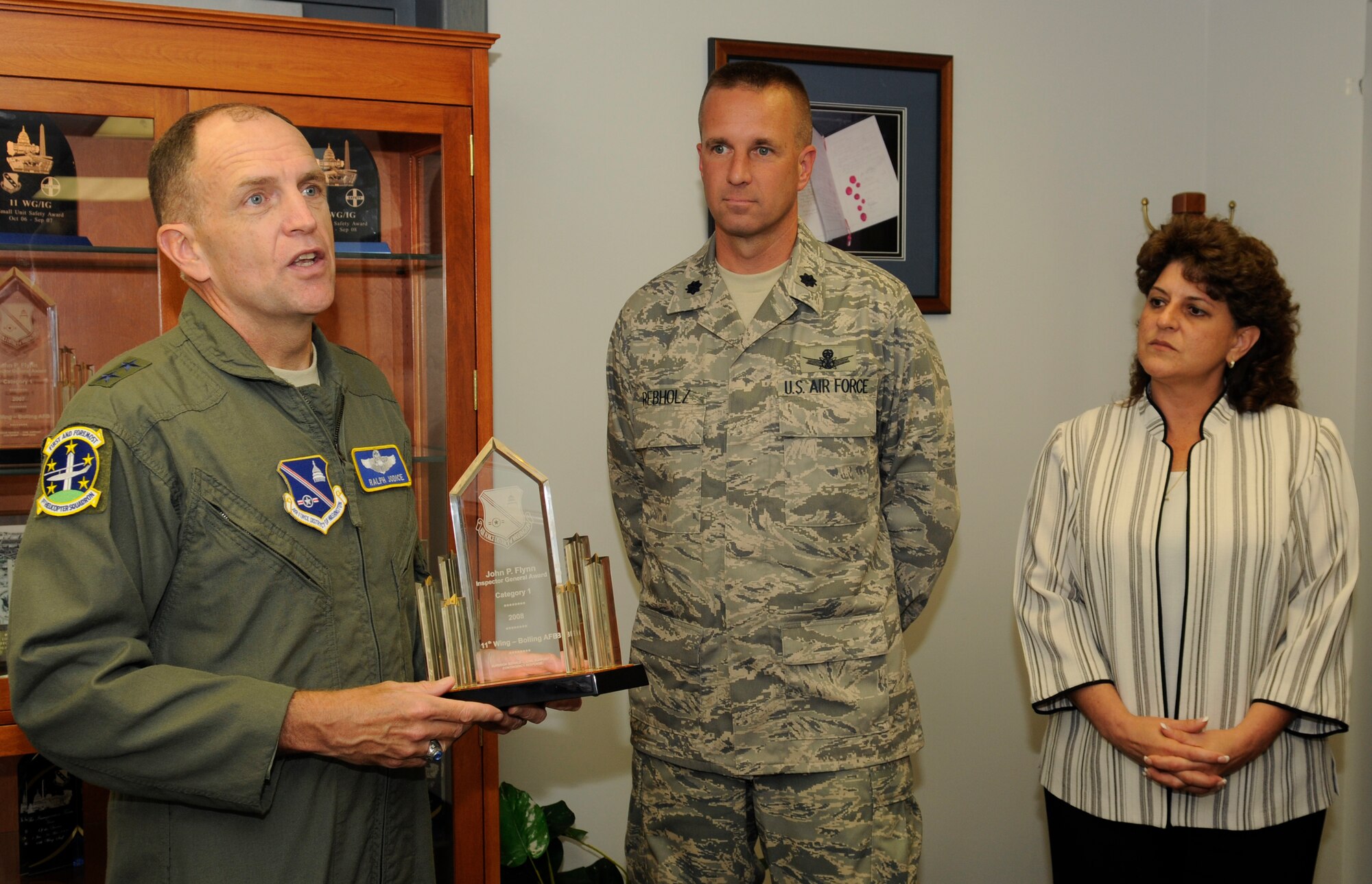Maj Gen. Ralph Jodice, Air Force District Washington commander, presents the John P. Flynn Award to Lt. Col. Alan F. Rebholz, 11th Wing inspector general, who accepted the honors on behalf of the 11th Wing IG Directorate May 27, 2009 in Hanger 1 on Bolling Air Force Base. The 11th Wing IG is the largest IG institution in the United States Air Force and provides service for any Airmen not supported by a major command. (U.S. Air Force photo by Staff Sgt. Dan DeCook)