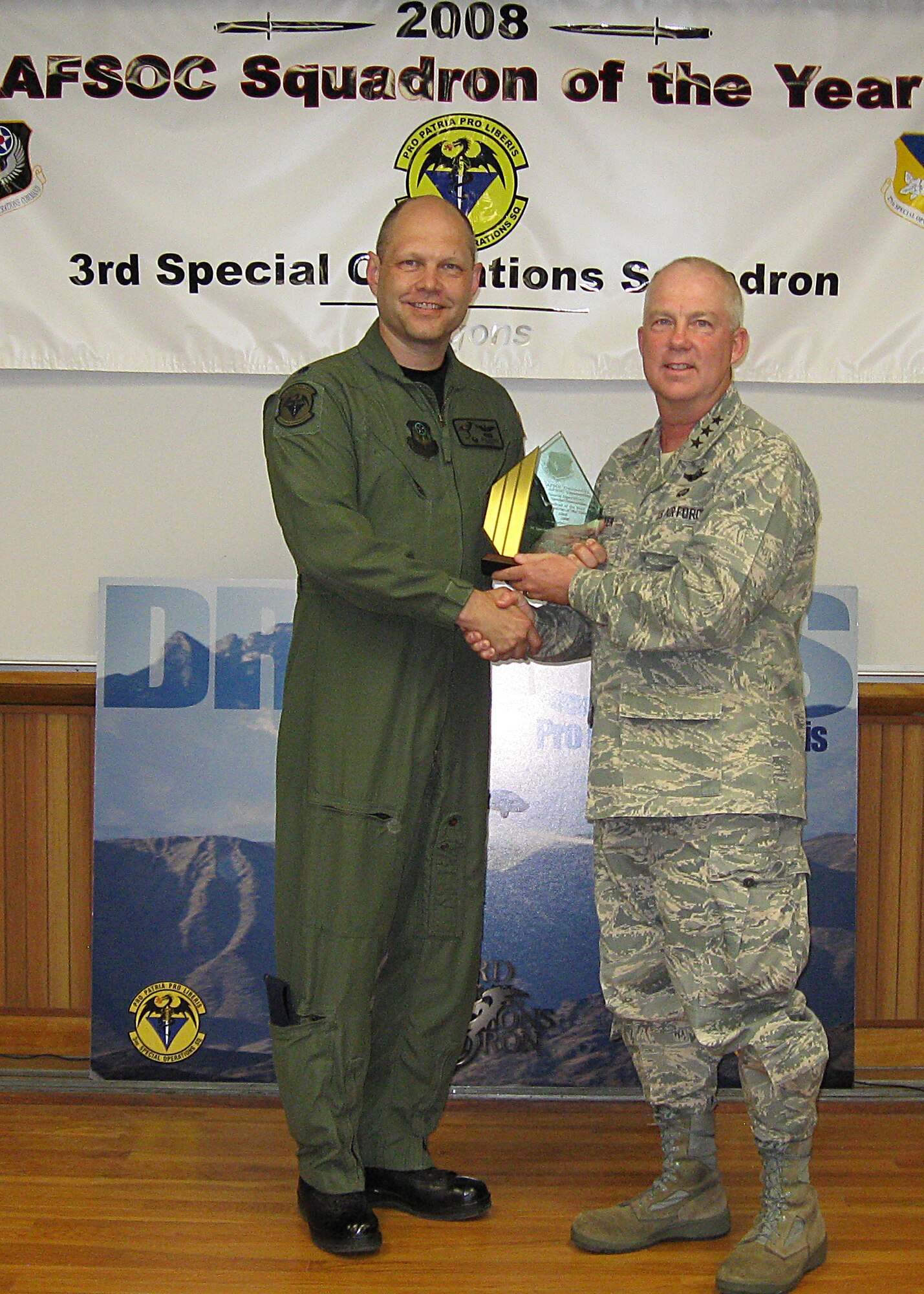 CANNON AIR FORCE BASE, N.M. -- Air Force Special Operations Command commander Lt. Gen Donald C. Wurster (right) presents the 2008 AFSOC Squadron of the Year trophy to Lt. Col. Bob W. Brock, 3rd Special Operations Squadron commander, during the AFSOC commanders visit to Cannon May 26. Among the   squadron's achievements were its successful efforts to move from Nellis Air Force Base, Nev., to Cannon with no degradation of mission capability or 24/7 support to fighting Overseas Contingency Operations as well as its people's efforts assisting and improving the communities where they've lived.   (U.S. Air Force photo by Staff Sgt. Luciano Vazquez)  